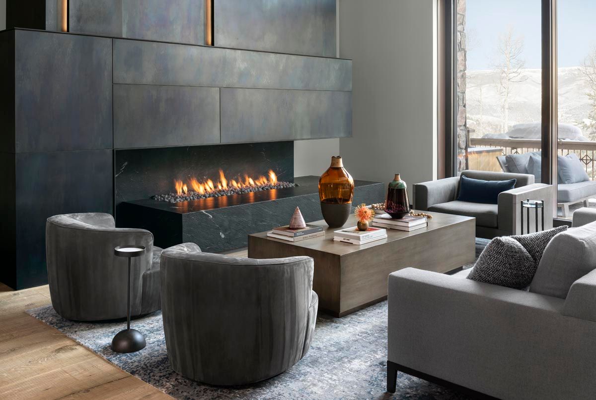 There is a fireplace in the middle of the living room.