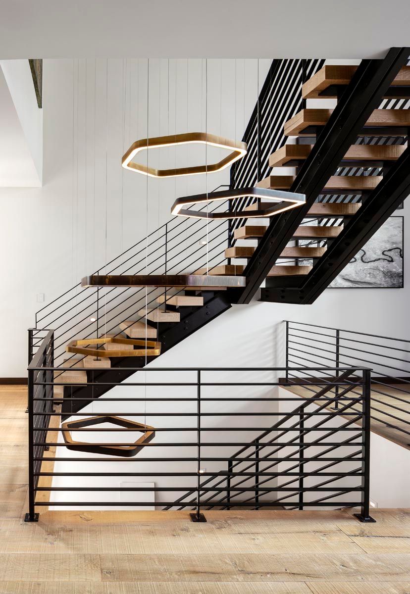 A modern staircase with wooden steps and a metal railing
