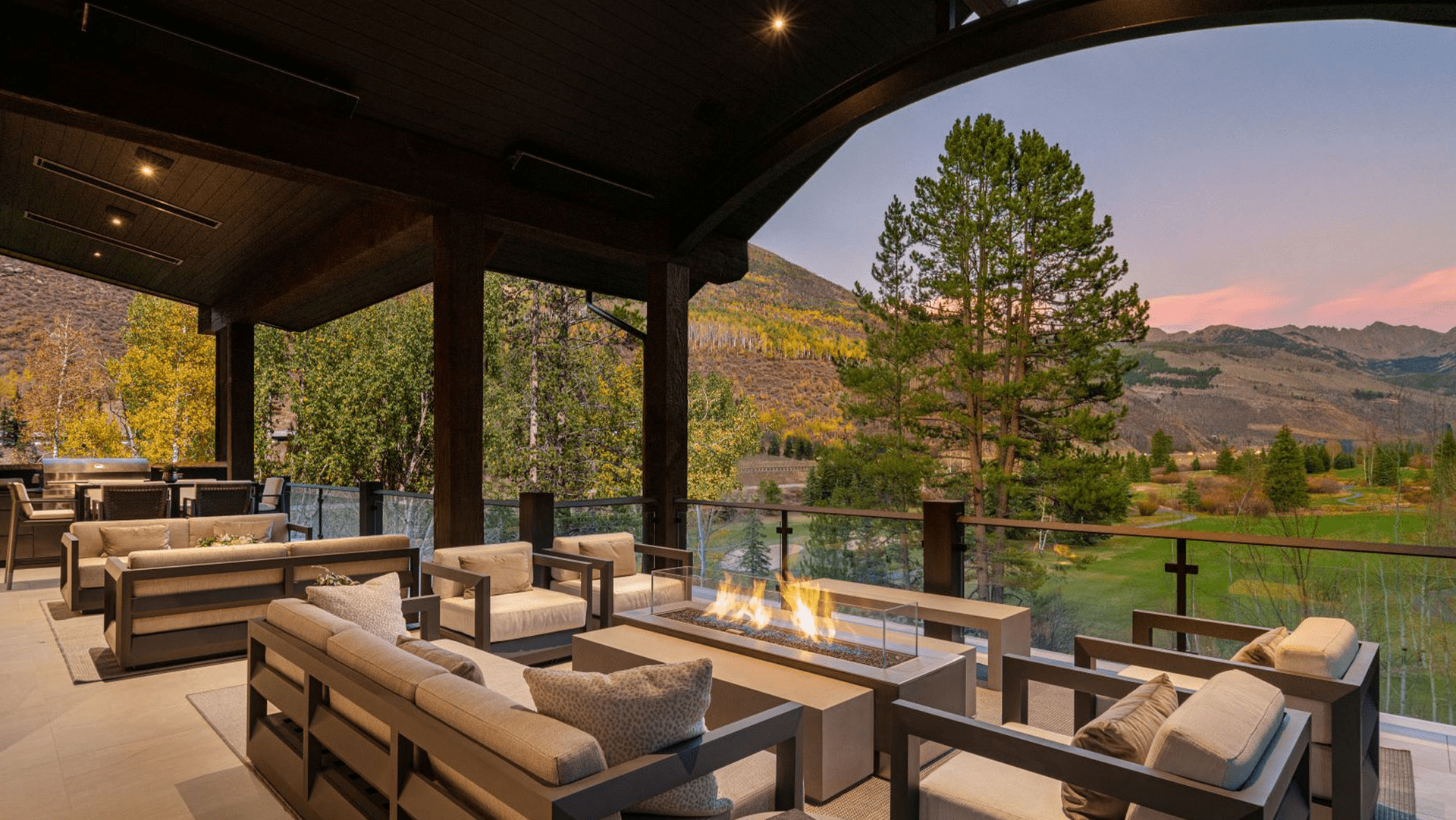 There is a fire pit on the patio with a view of the mountains.