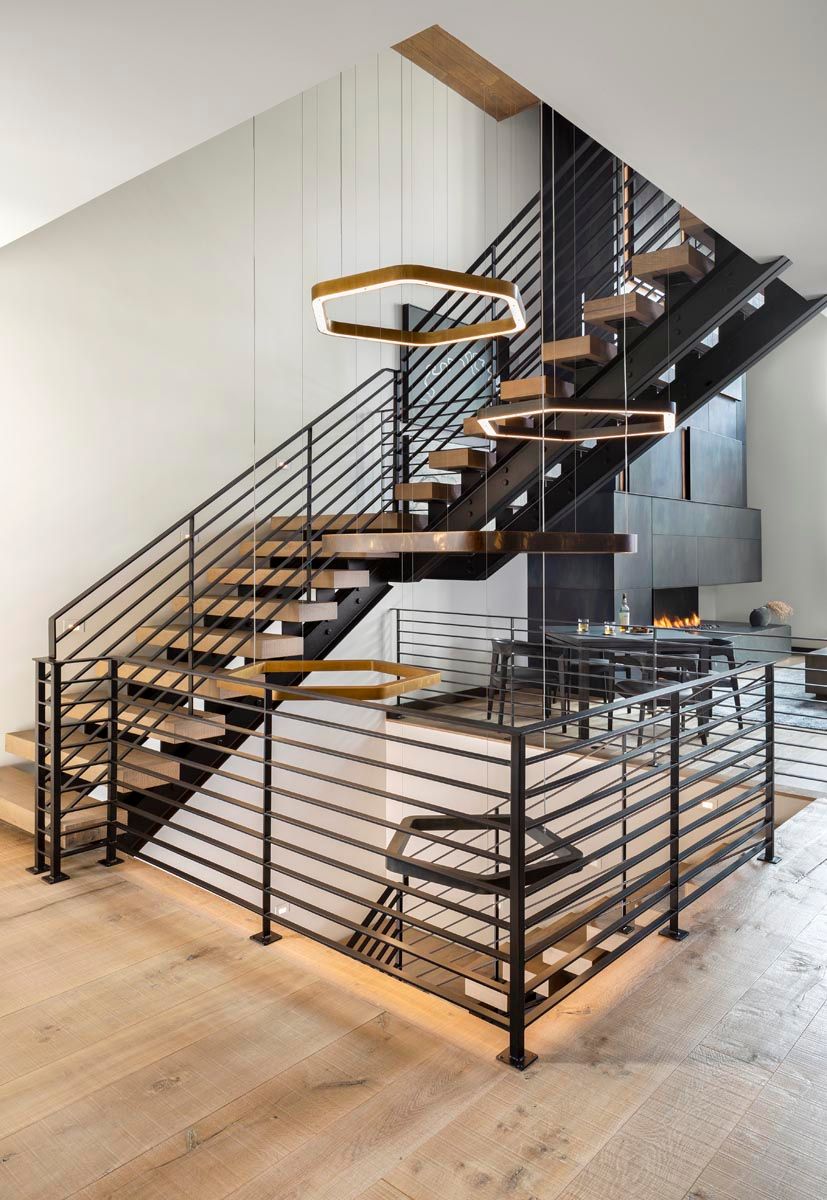 A modern staircase with wooden steps and a metal railing