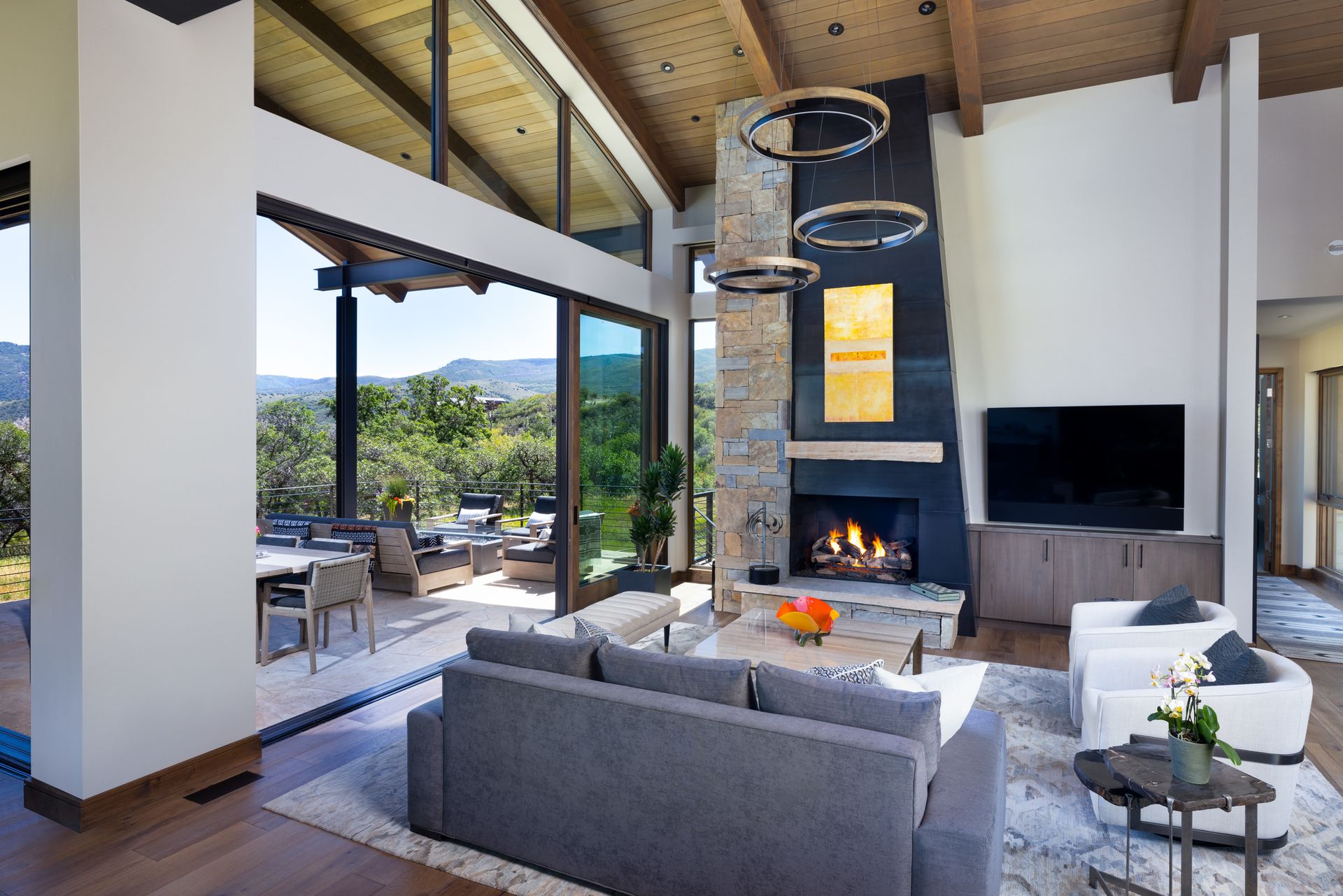 A living room with a couch , fireplace and television.