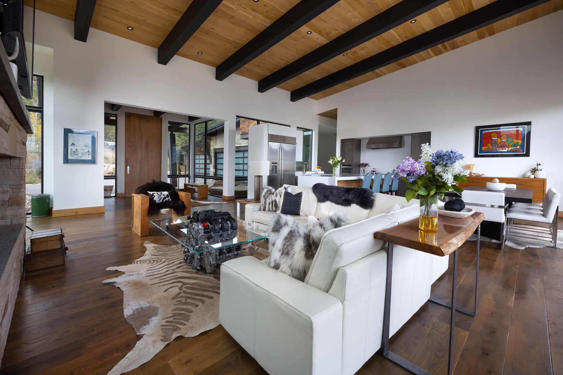 A living room with a white couch and a cowhide rug