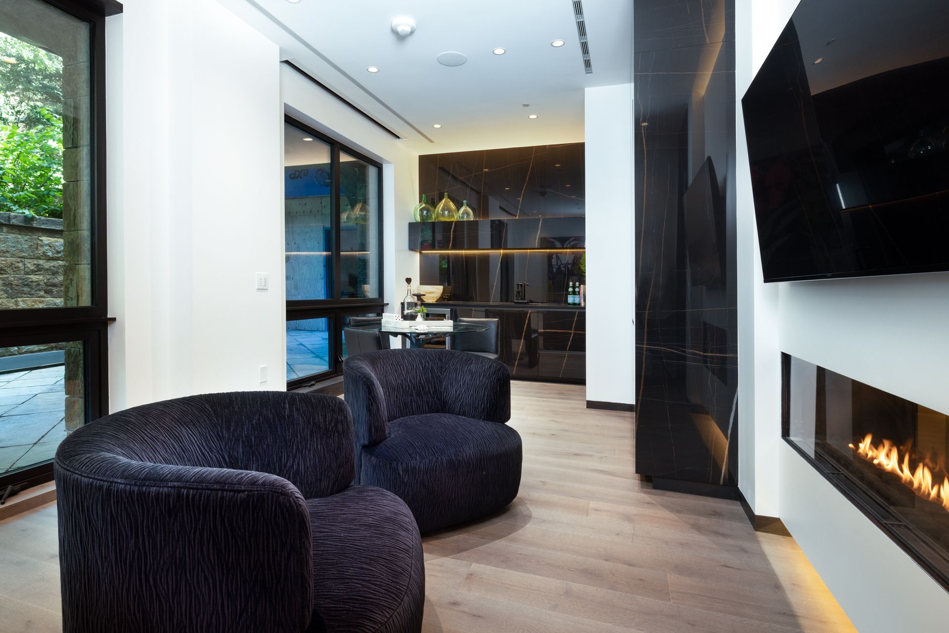 A living room with two chairs and a fireplace