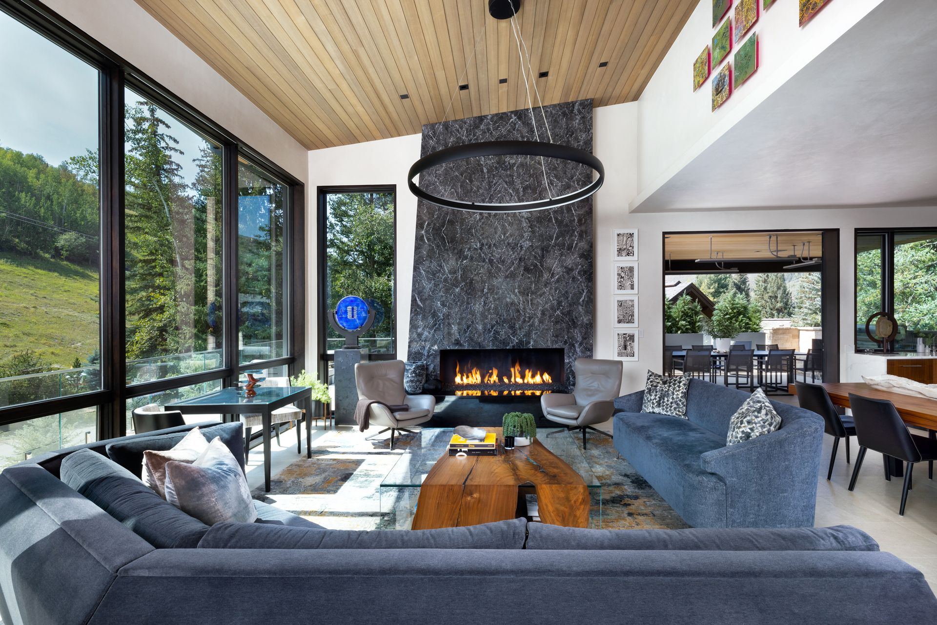 A living room with a fireplace and a lot of windows