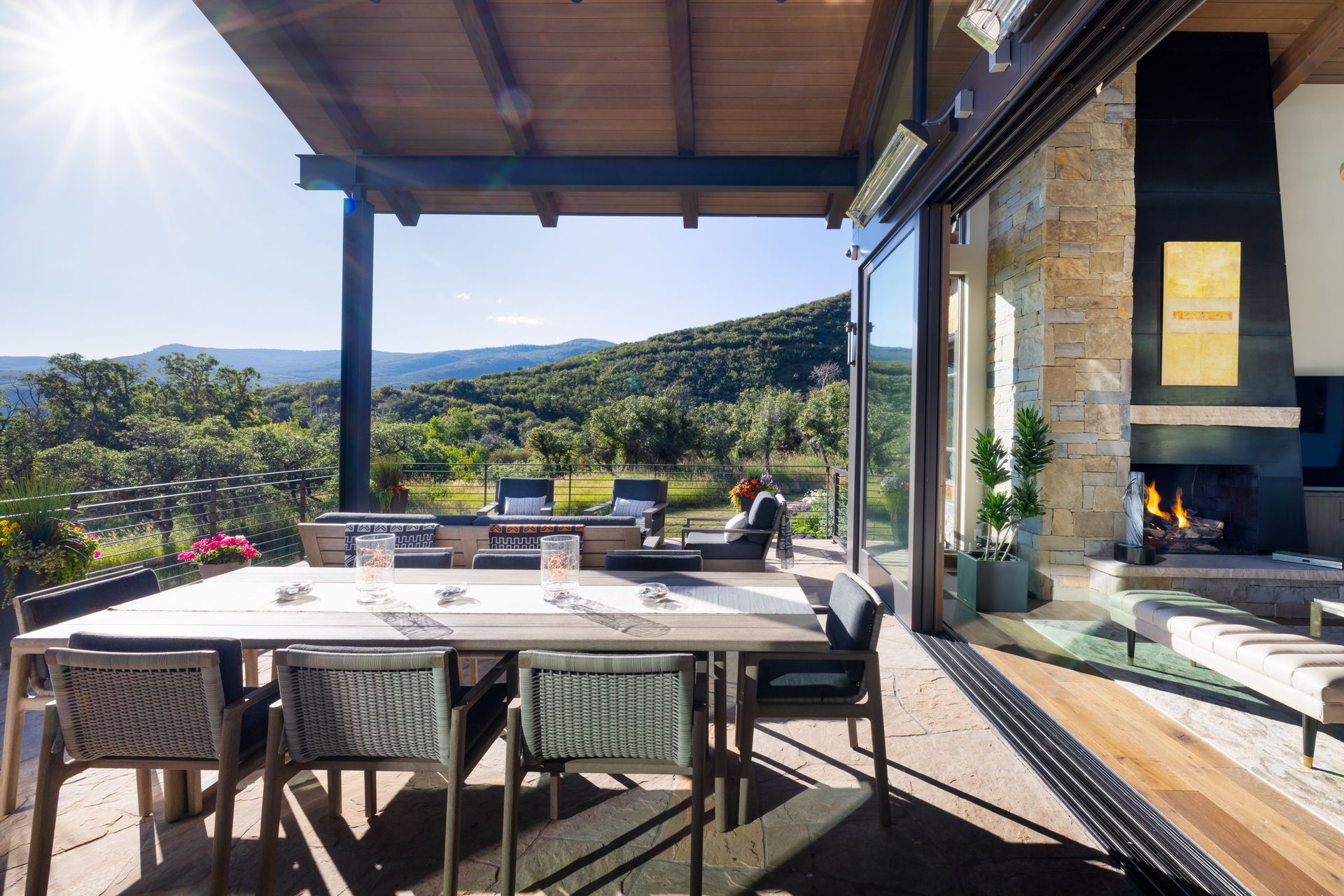 A patio with a table and chairs and a fireplace.