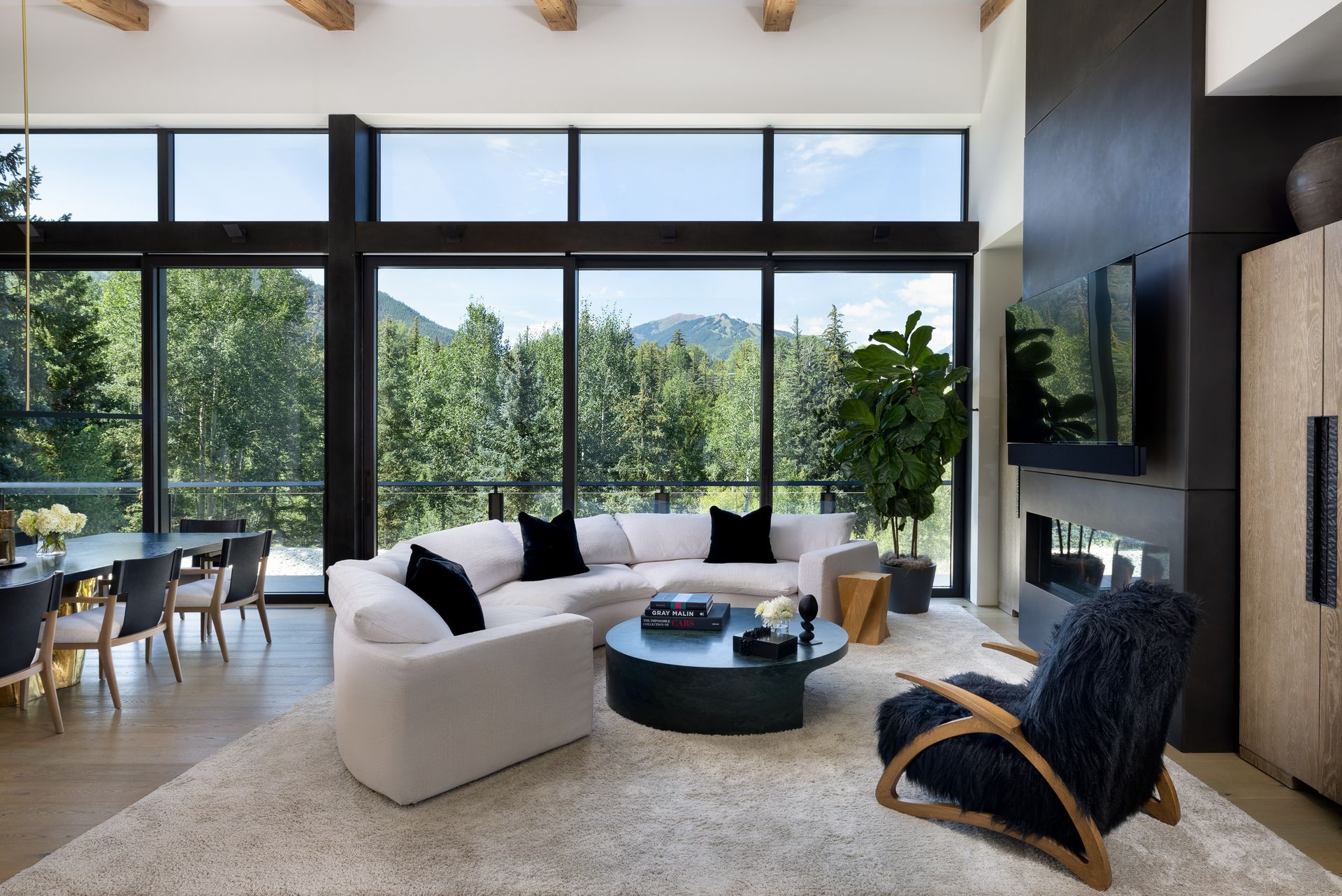 A living room with a couch , chair , table , and television.