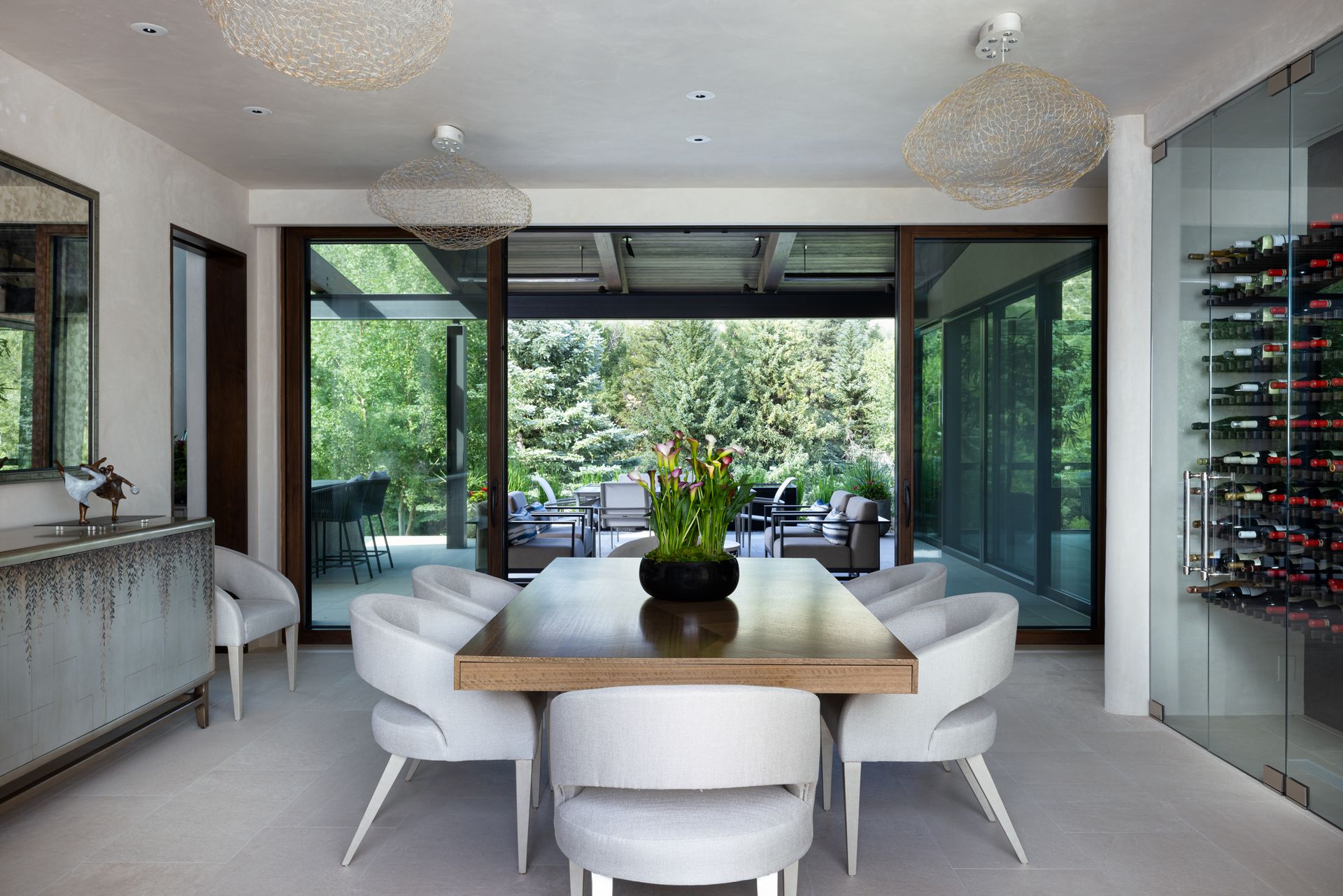 A dining room with a table and chairs and a wine cellar