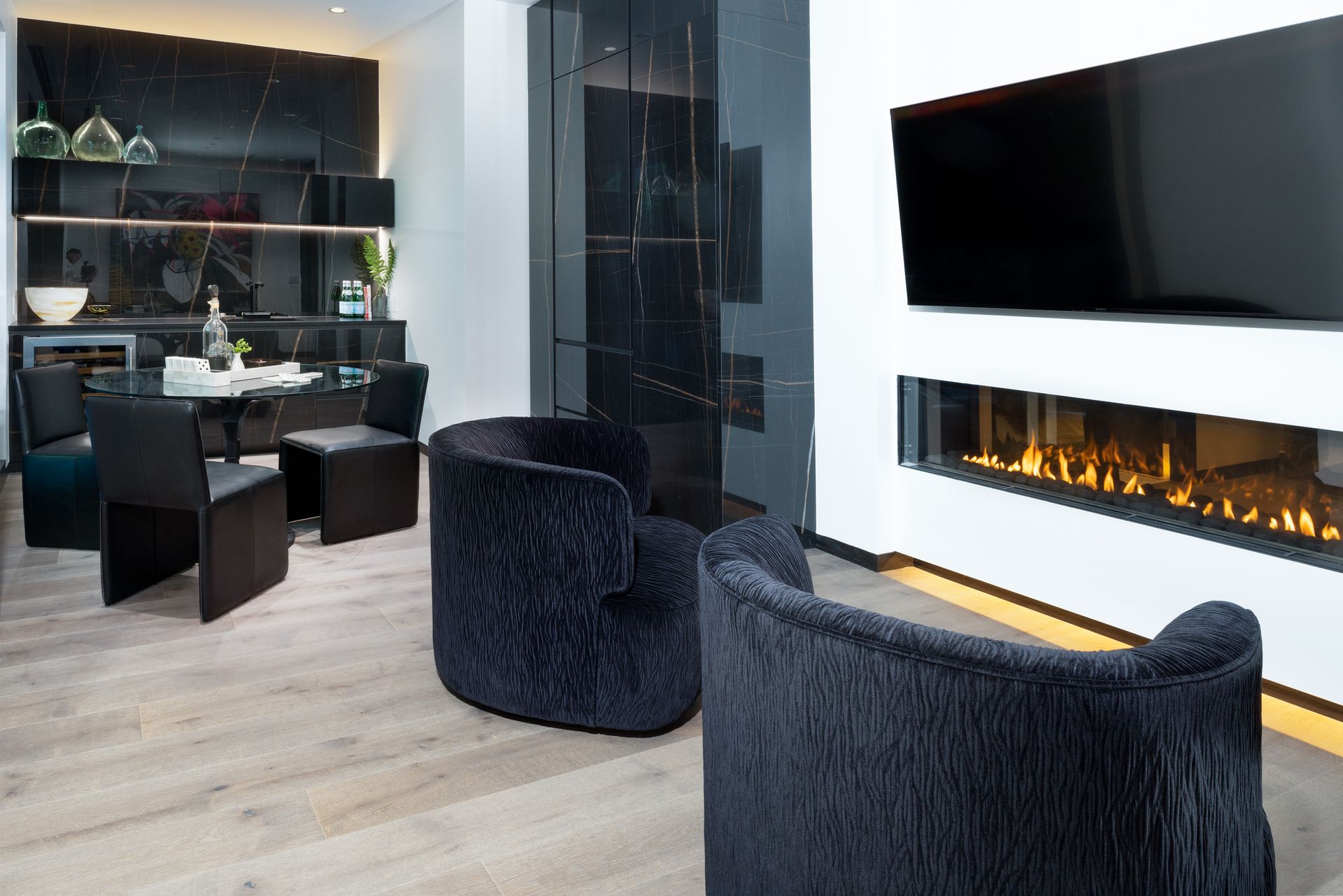 A living room with two chairs and a fireplace.