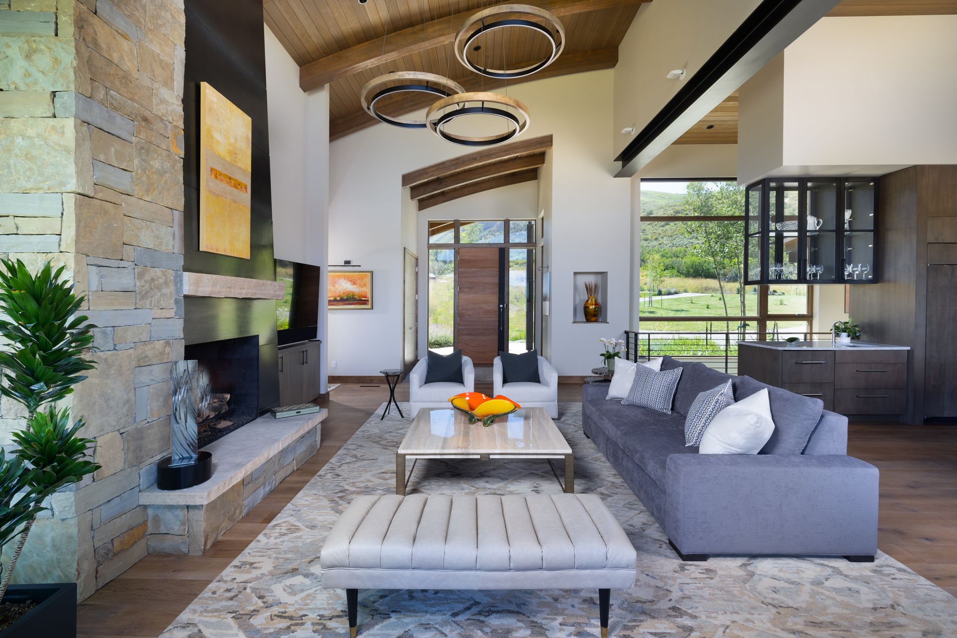 A living room with a couch , chairs , coffee table and fireplace.