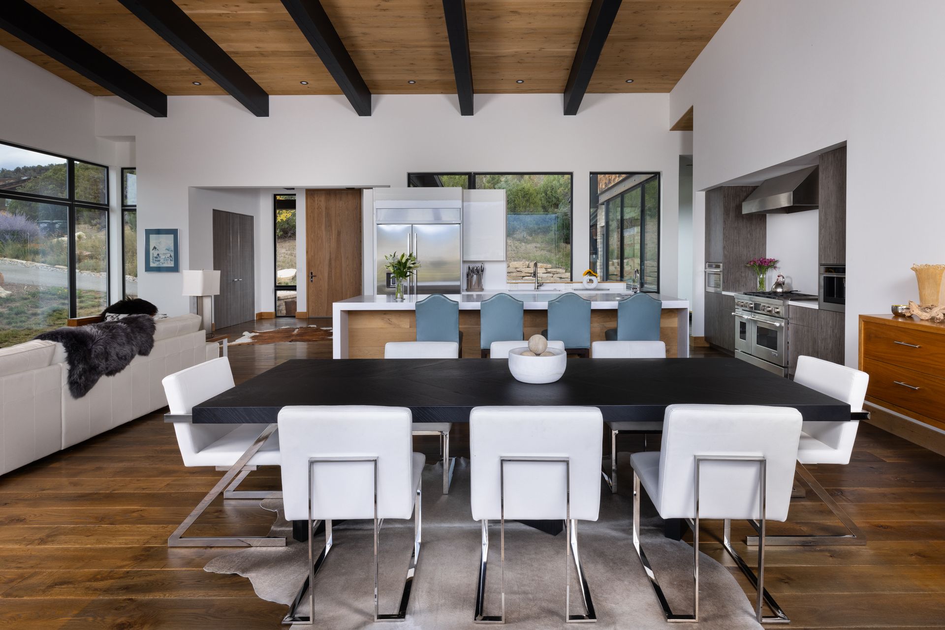 There is a dining table and chairs in the middle of the room.