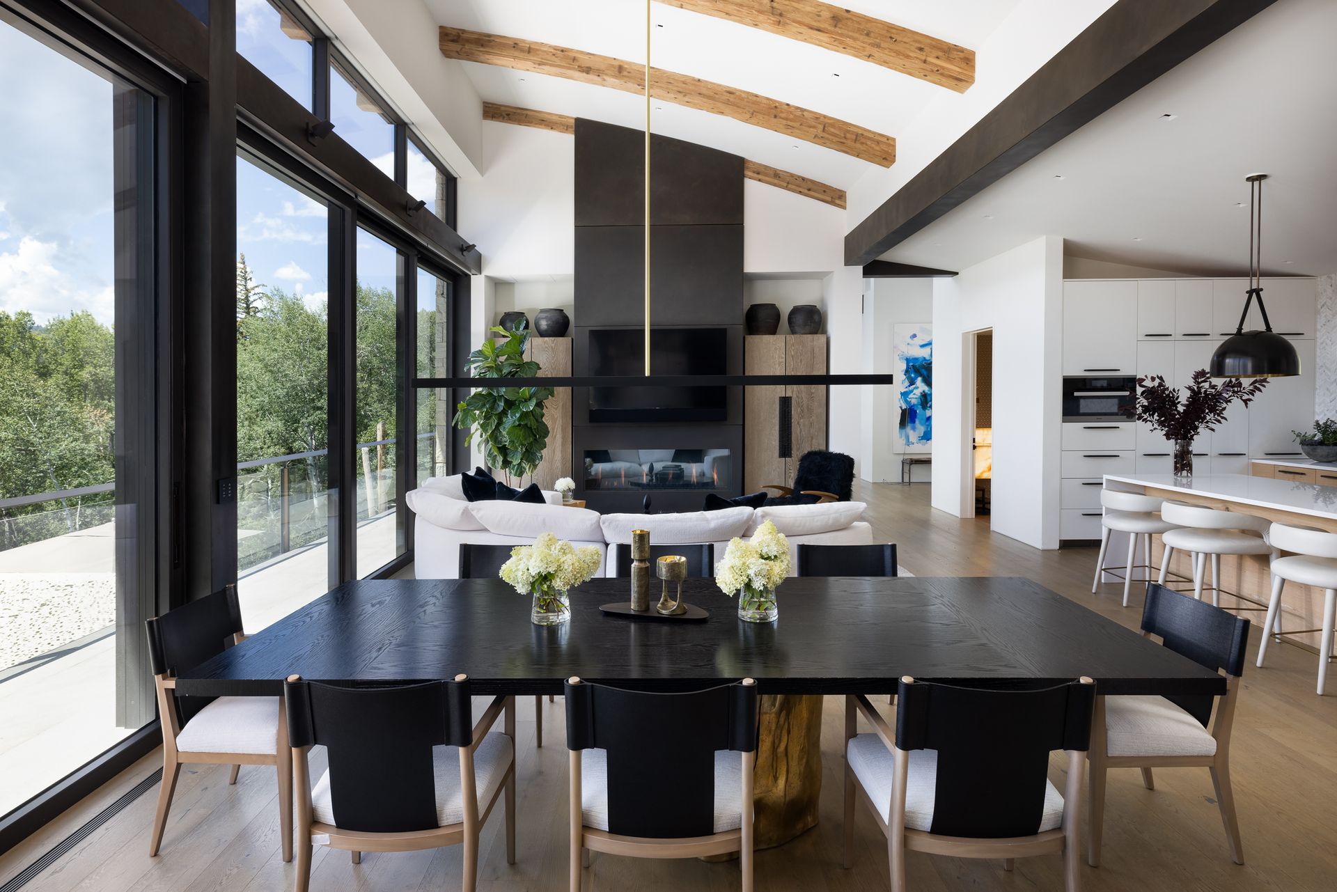 A large dining room with a black table and chairs
