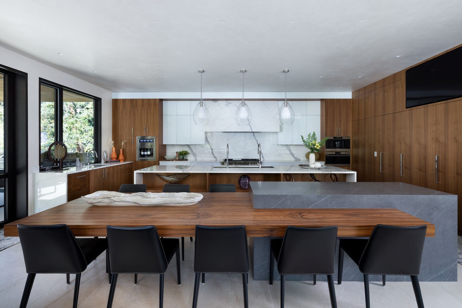 A kitchen with a dining table and chairs in it.