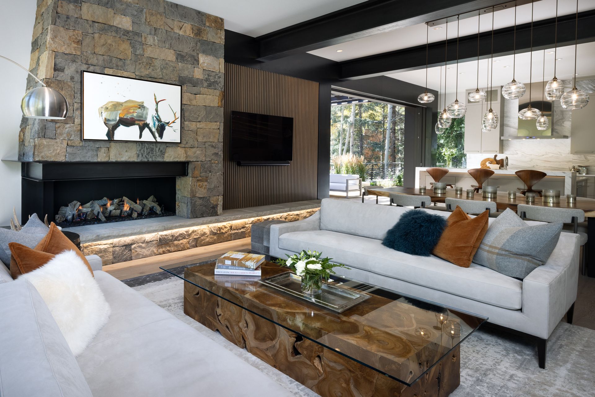 A living room with two couches , a fireplace , and a television.