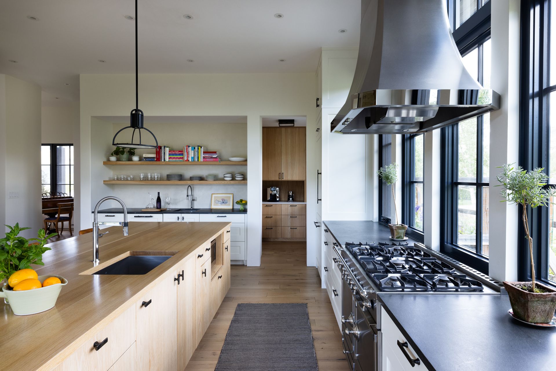 A kitchen with a stove top oven and a sink