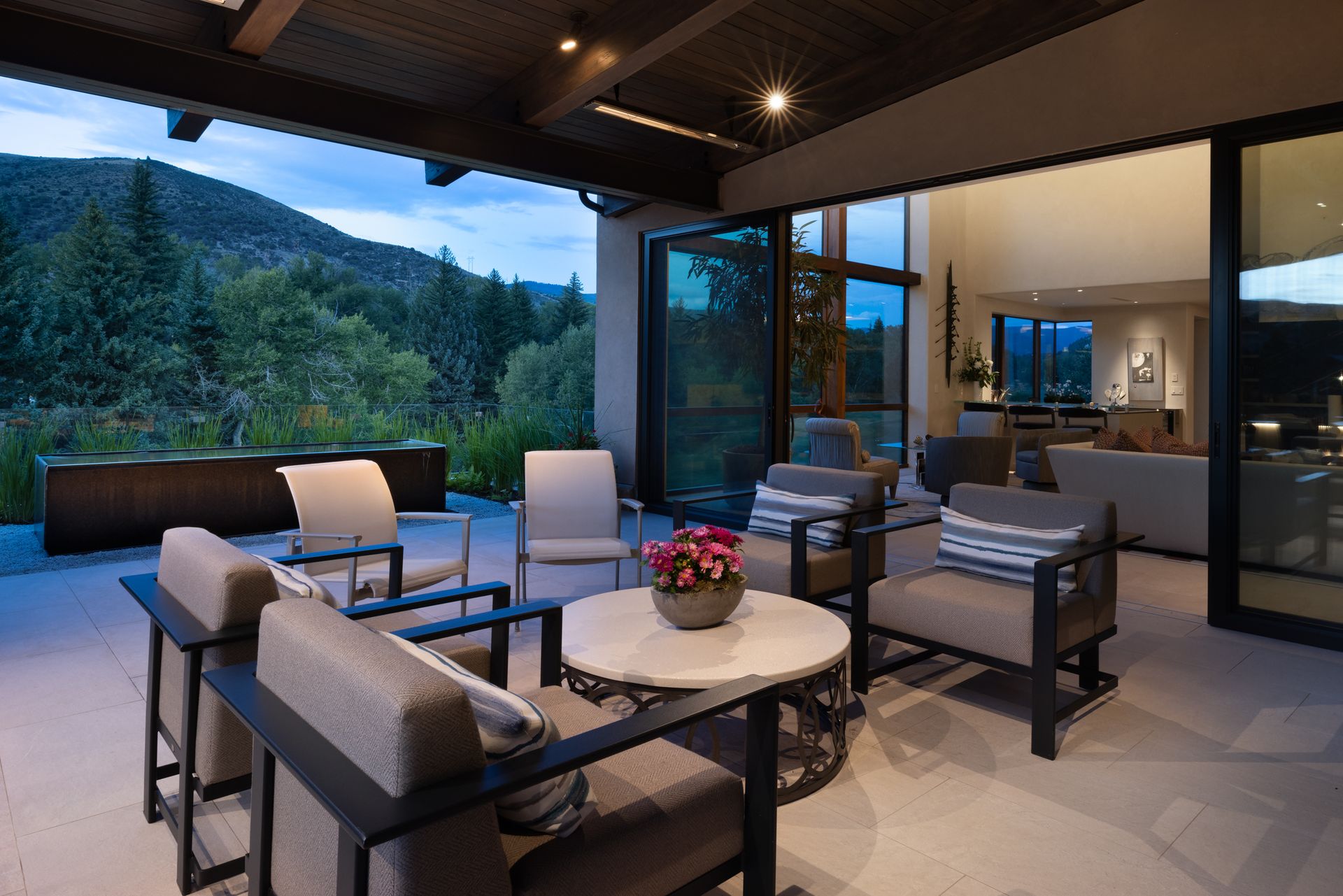 A living room with a lot of furniture and a view of the mountains