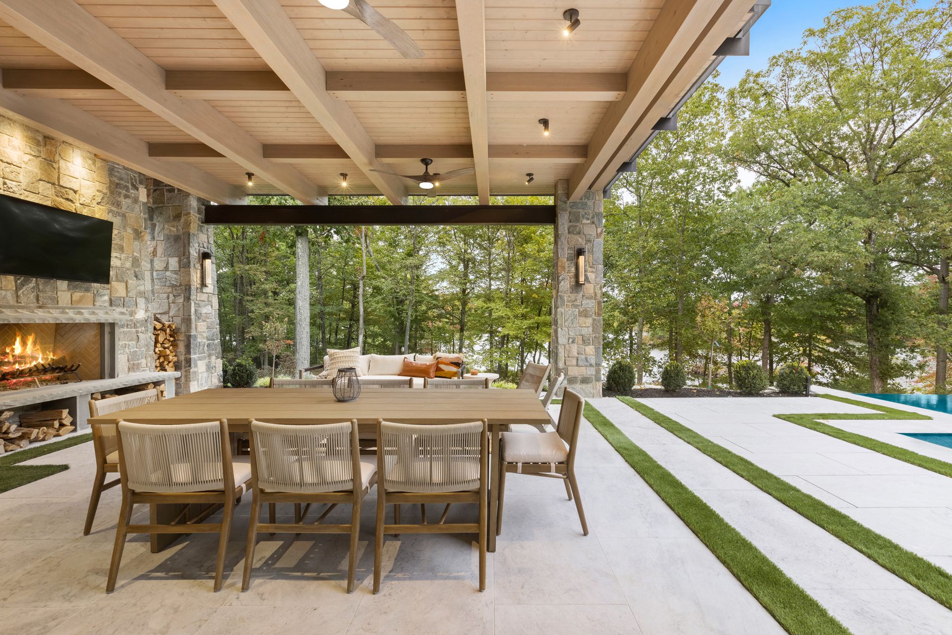 A patio with a table and chairs and a fireplace.