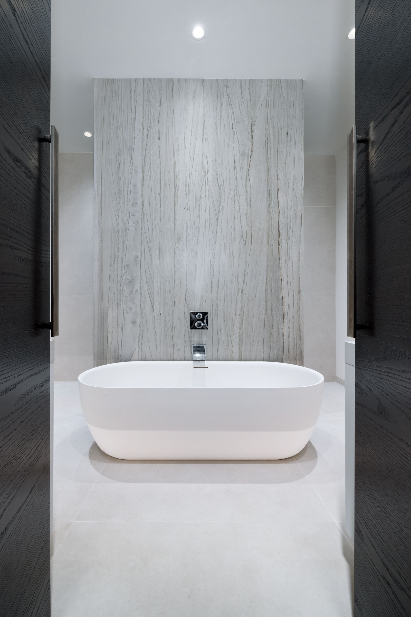 There is a bathtub in the middle of the bathroom.