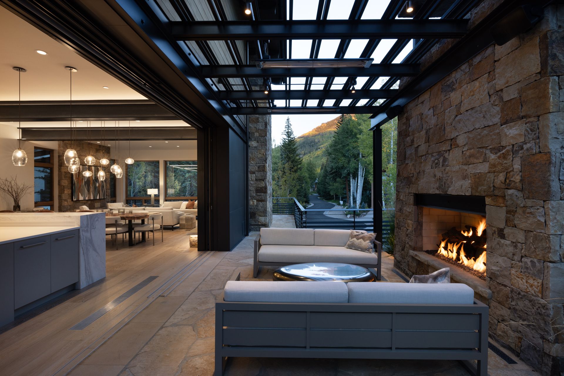 A living room with a couch , coffee table , fireplace and television.