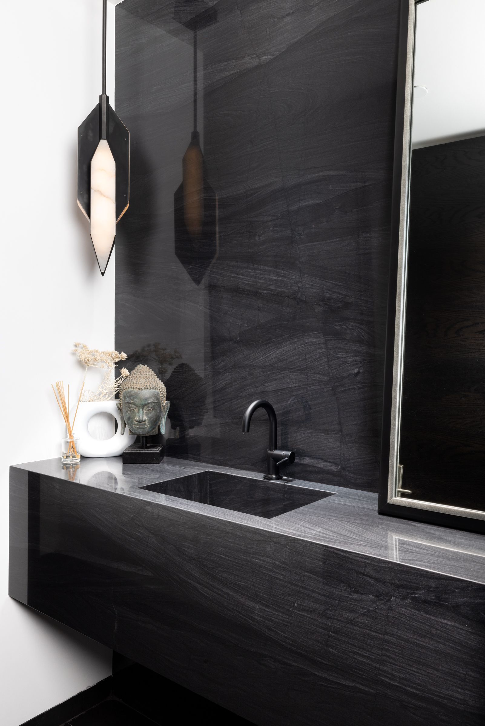 A bathroom with a sink and a mirror on the wall