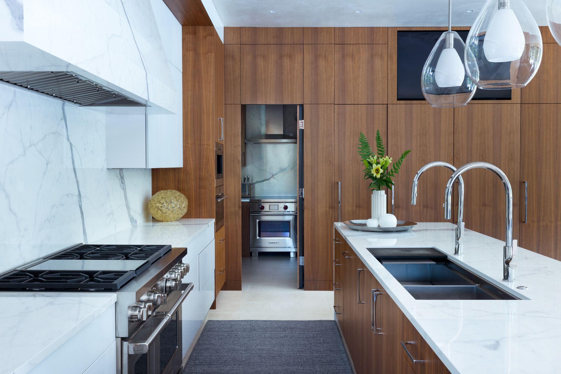 A kitchen with a stove , sink , and refrigerator.