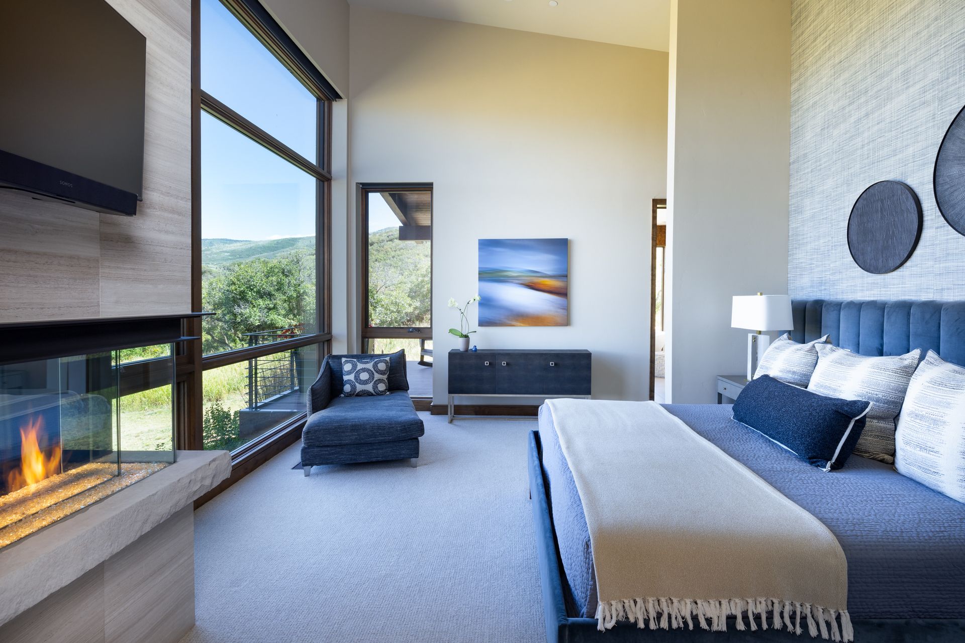 A bedroom with a fireplace and a large bed