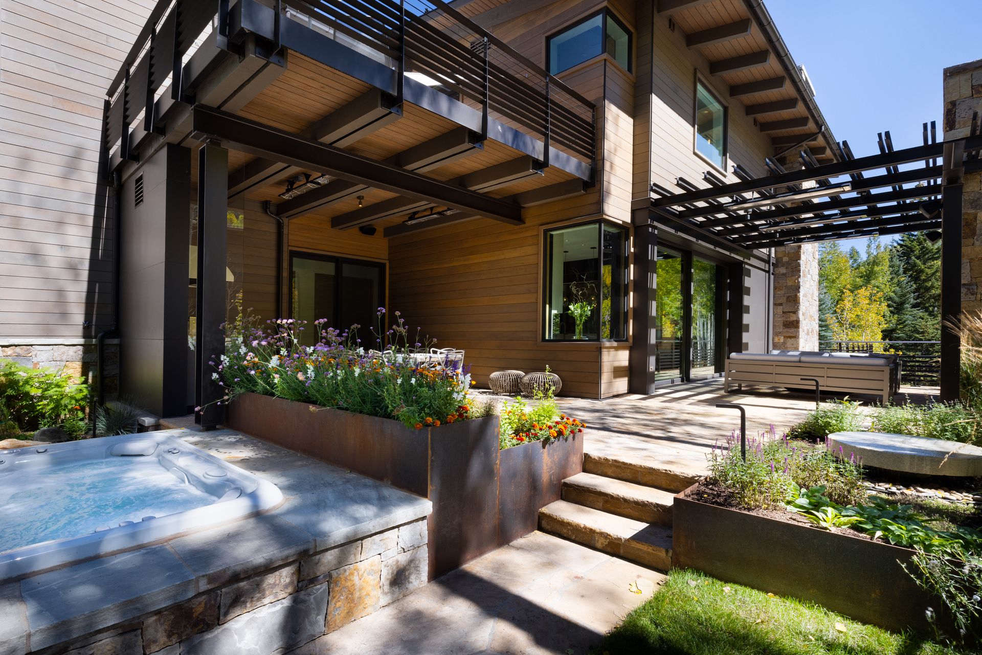 A house with a pergola and stairs leading to it.