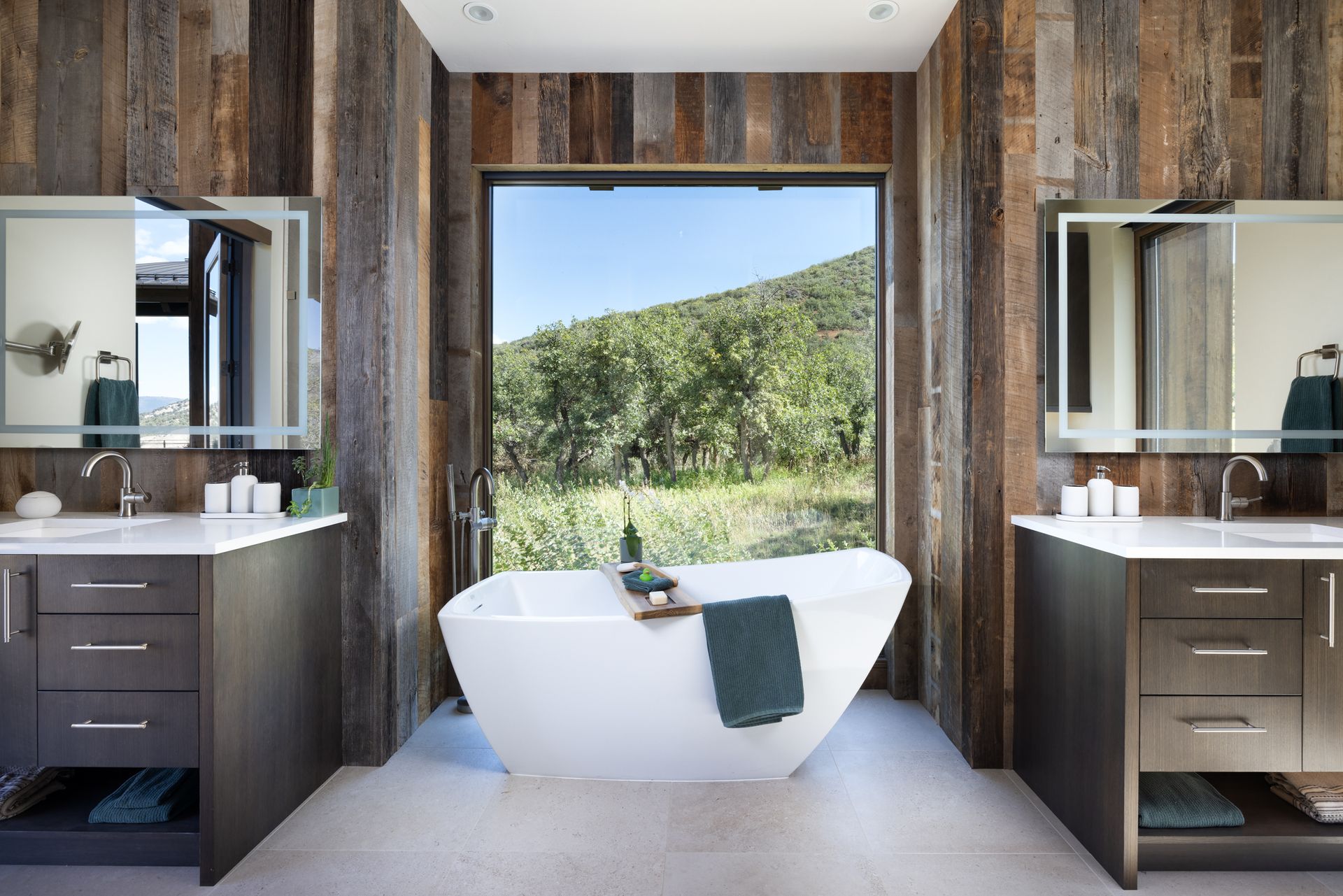A bathroom with a bathtub and two sinks