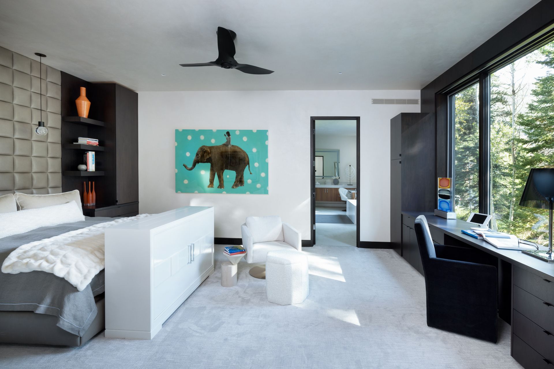 A bedroom with a painting of an elephant on the wall