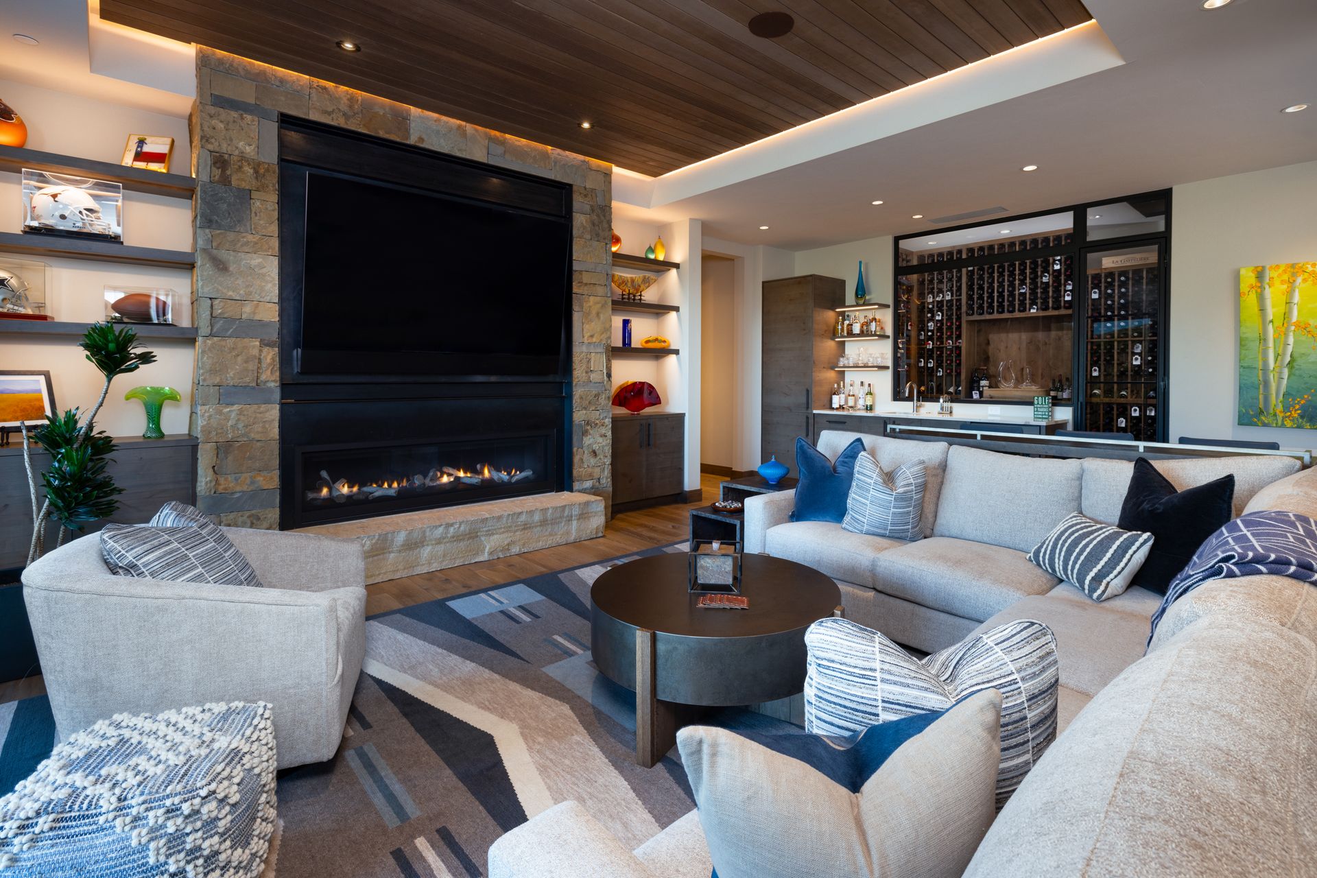 A living room with a couch , chairs , a fireplace and a flat screen tv.