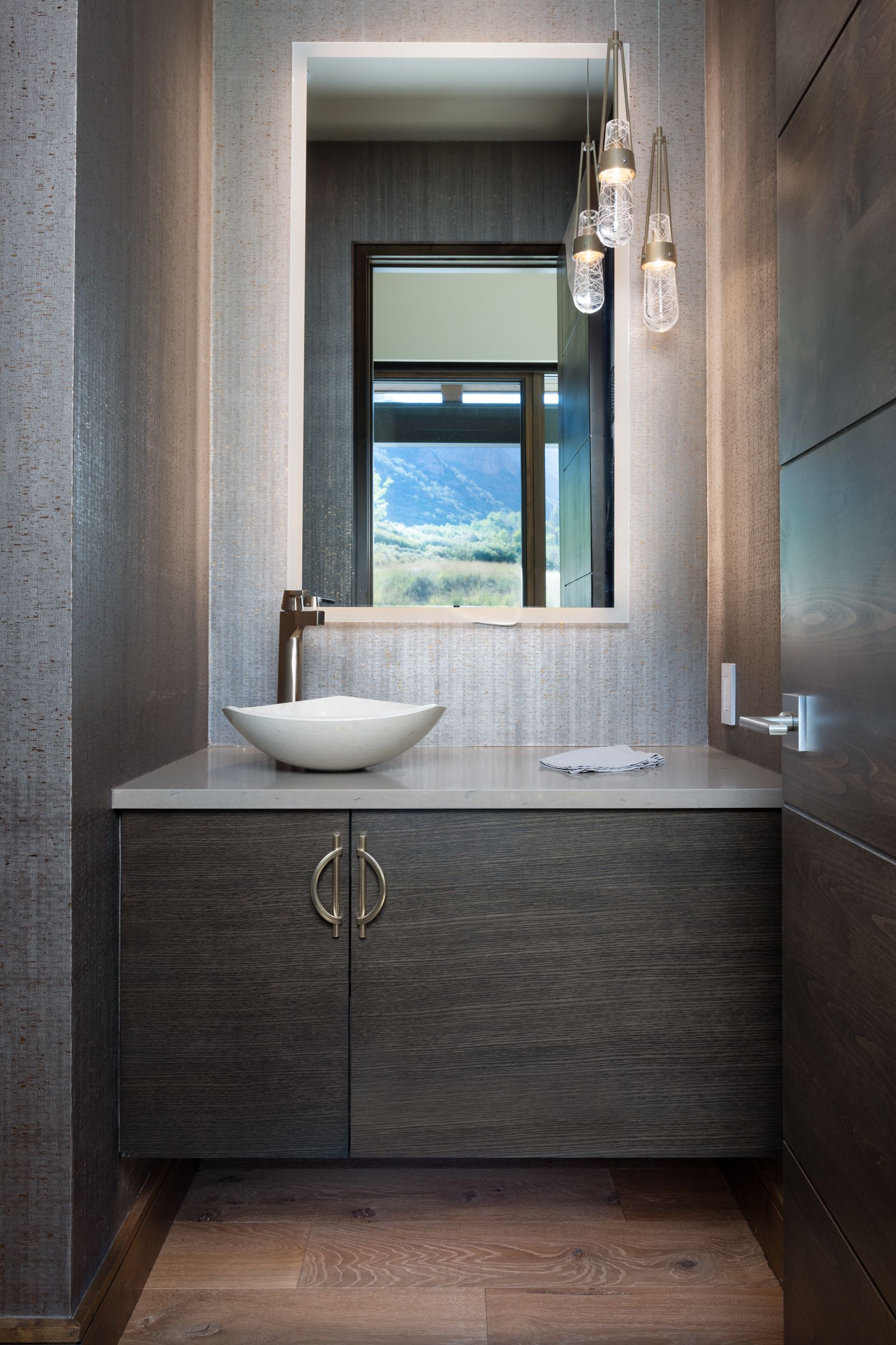 A bathroom with a sink , mirror and cabinets.