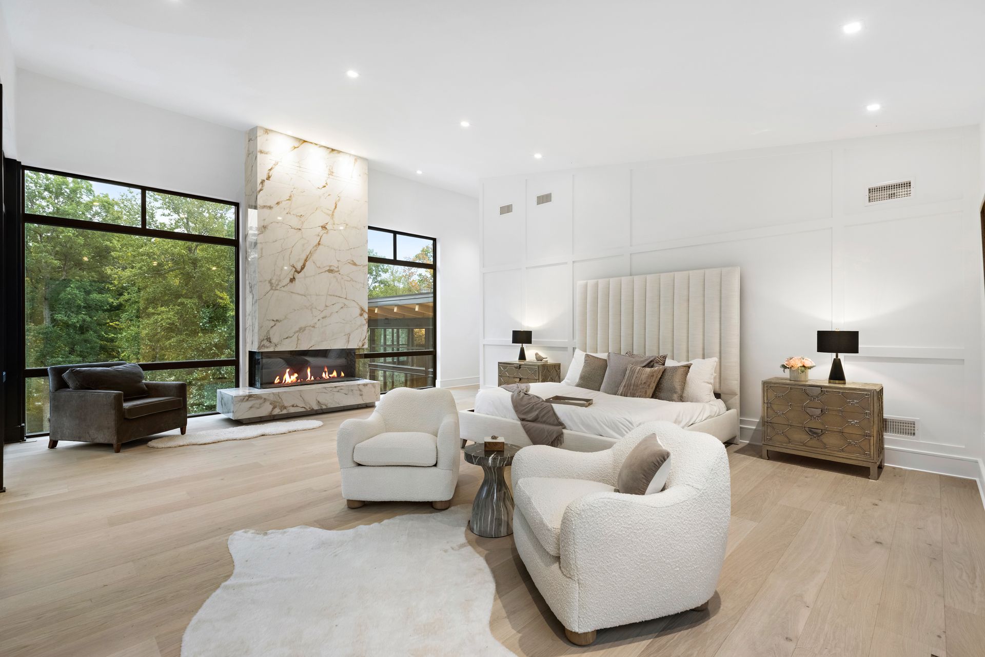 A large bedroom with a fireplace and a large bed