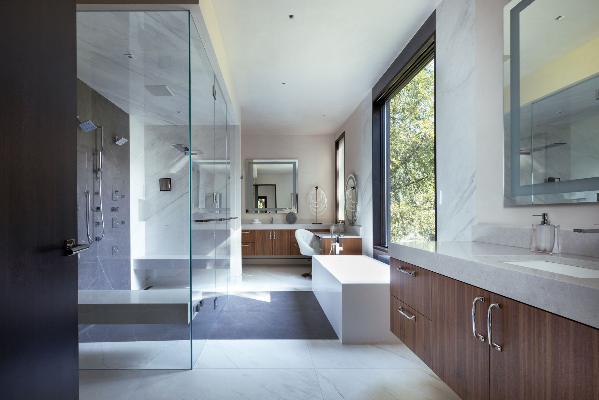 A bathroom with a walk in shower and a bathtub