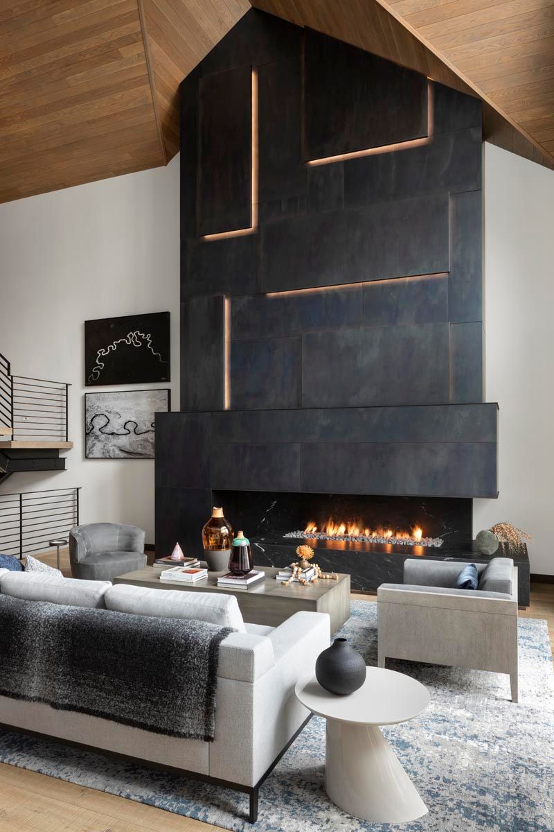 There is a fireplace in the middle of the living room.