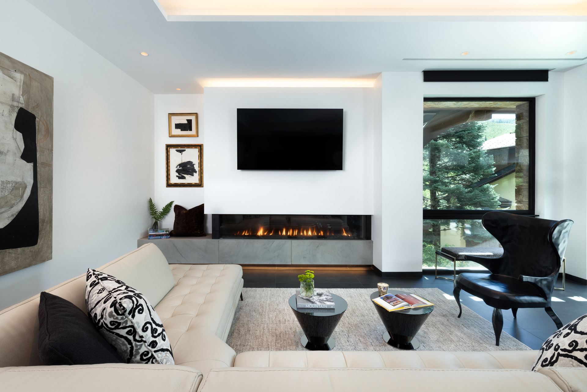 A living room with a fireplace and a flat screen tv