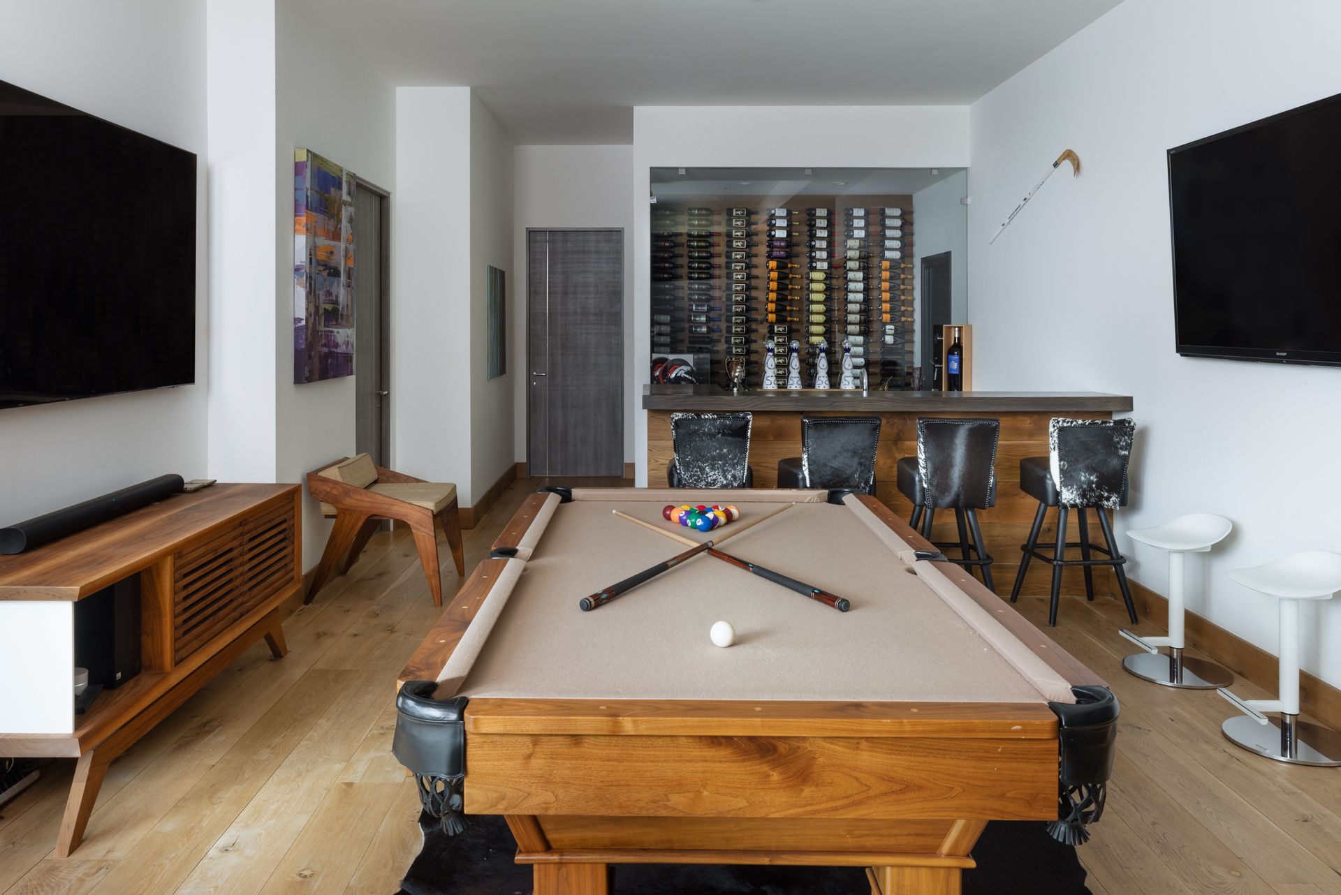 There is a pool table in the middle of the room.