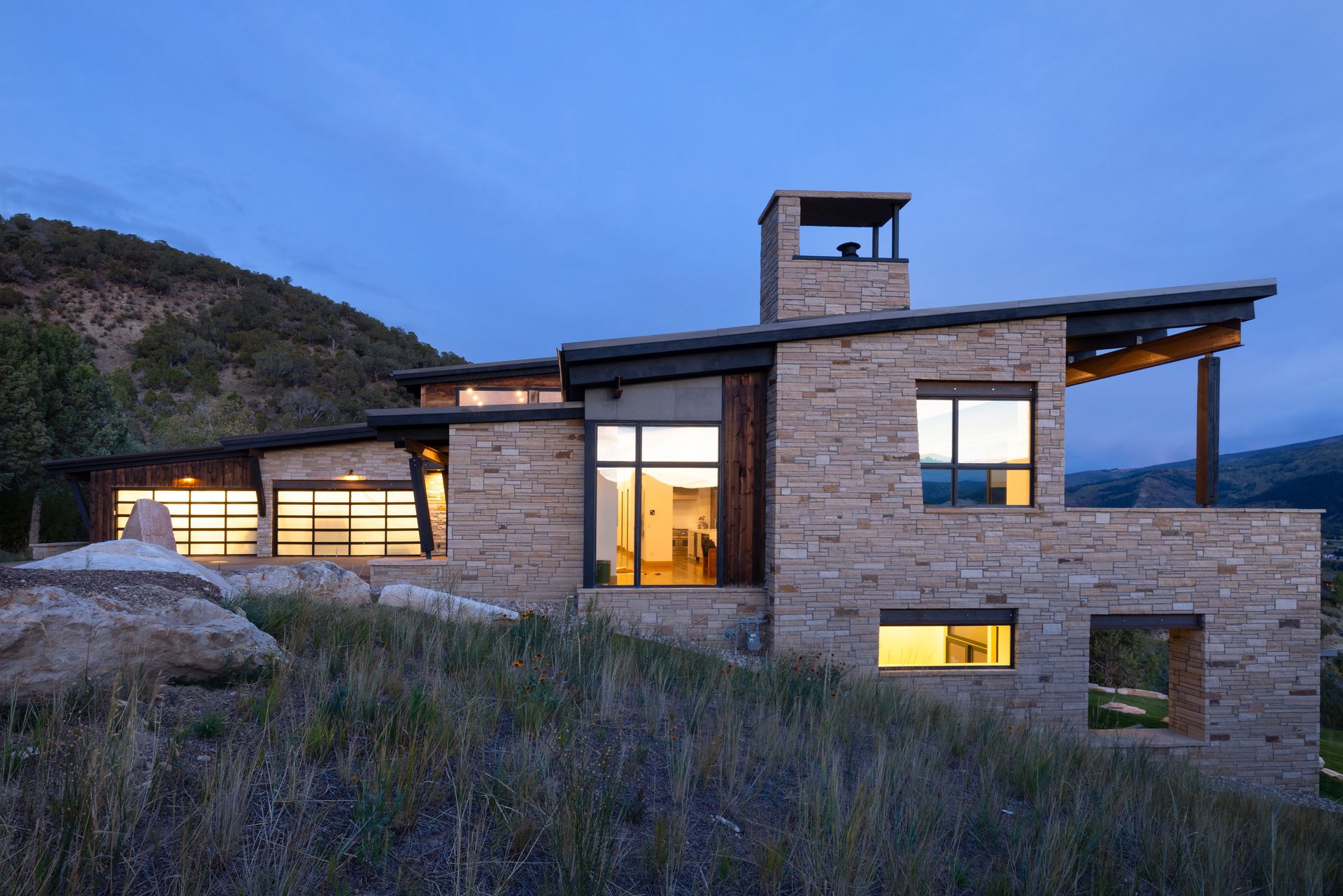 A large stone house is sitting on top of a hill.