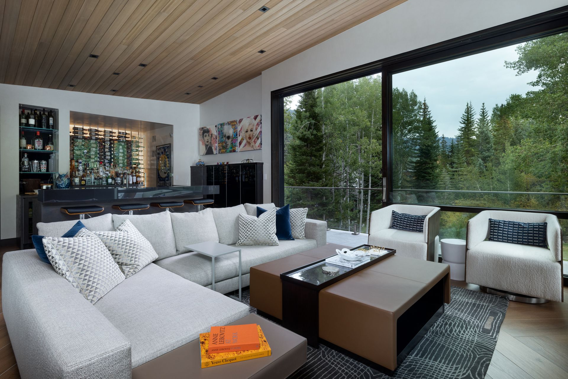 A living room with a couch and chairs and a large window