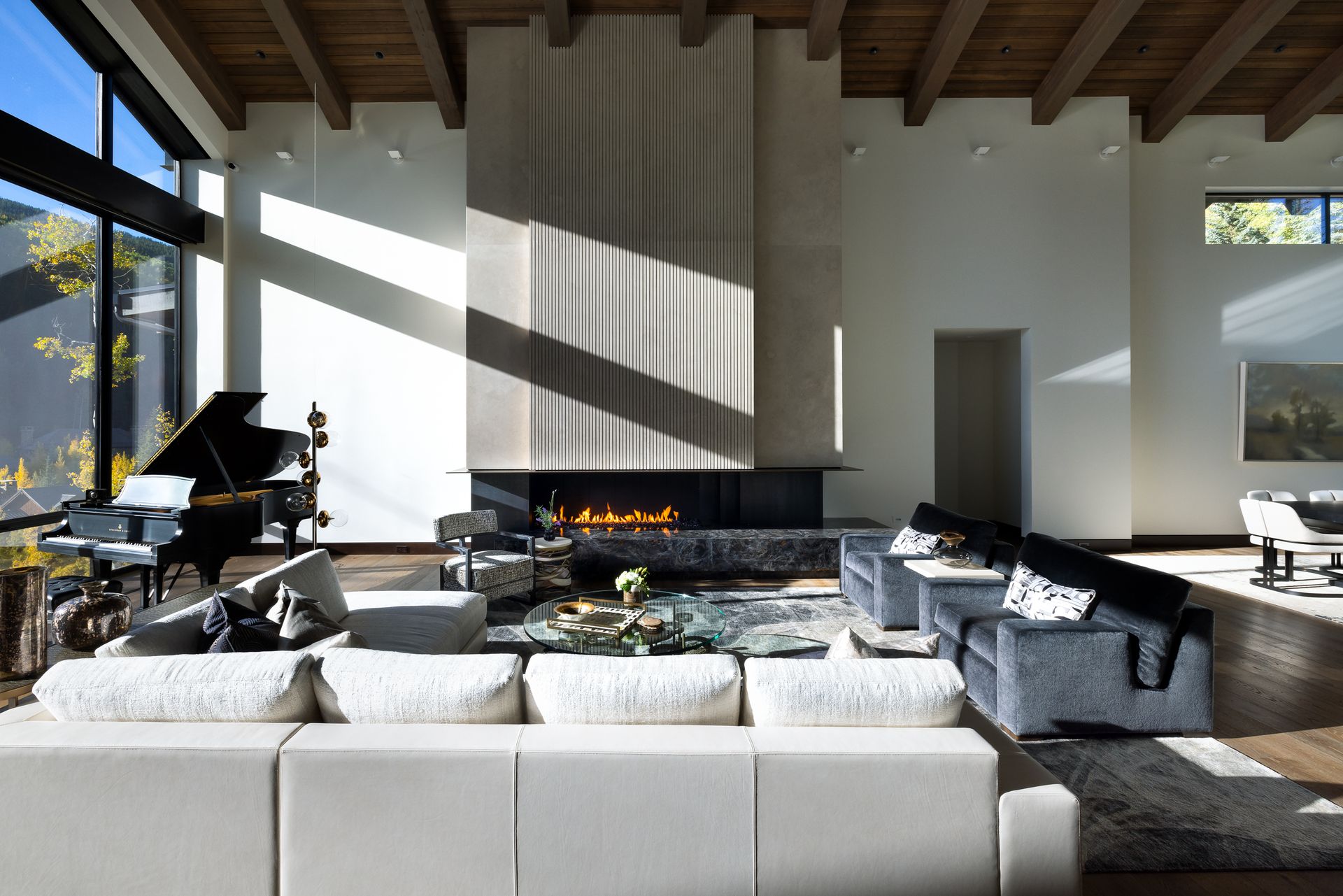 A living room with a piano and a fireplace