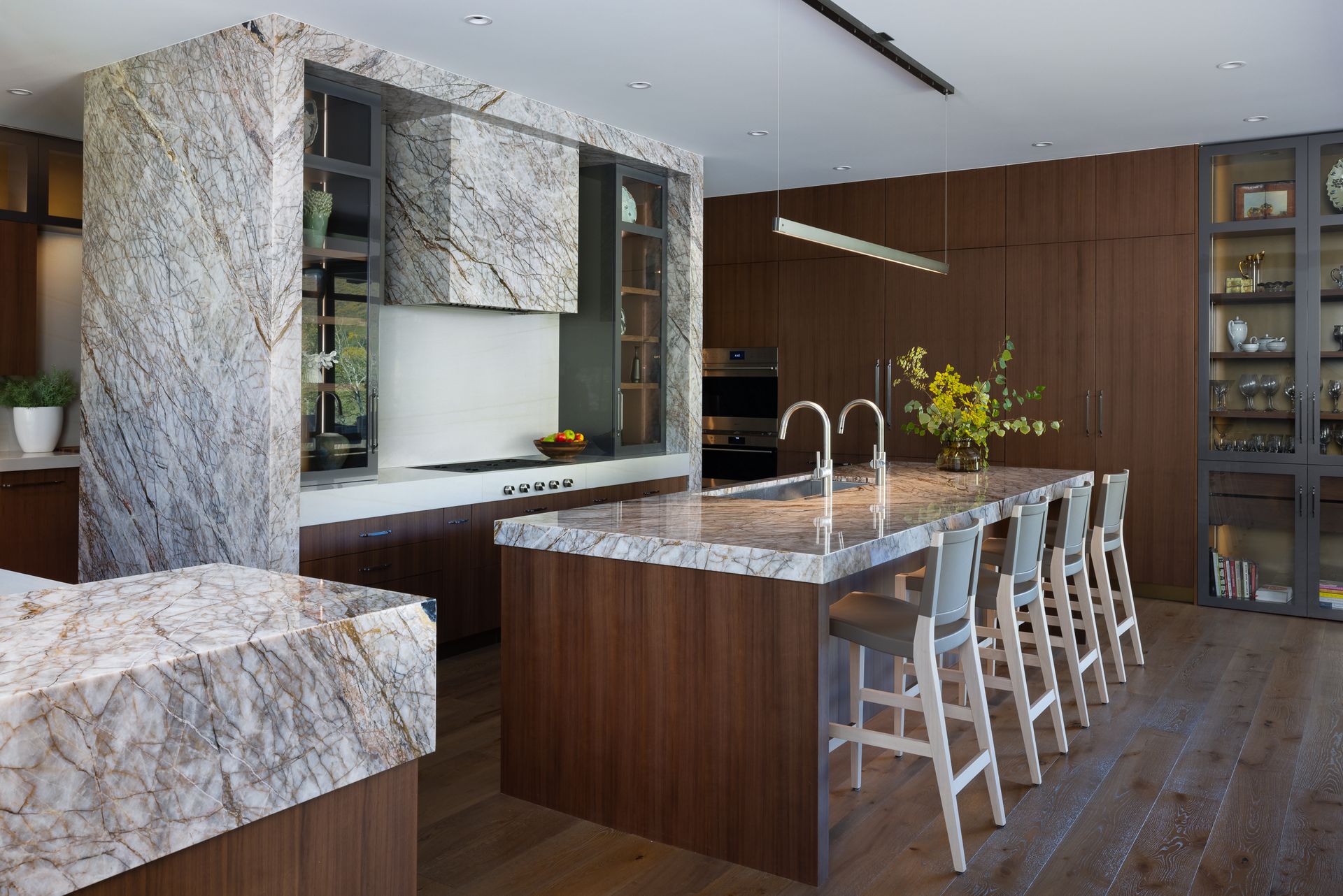 A kitchen with marble counter tops and wooden cabinets