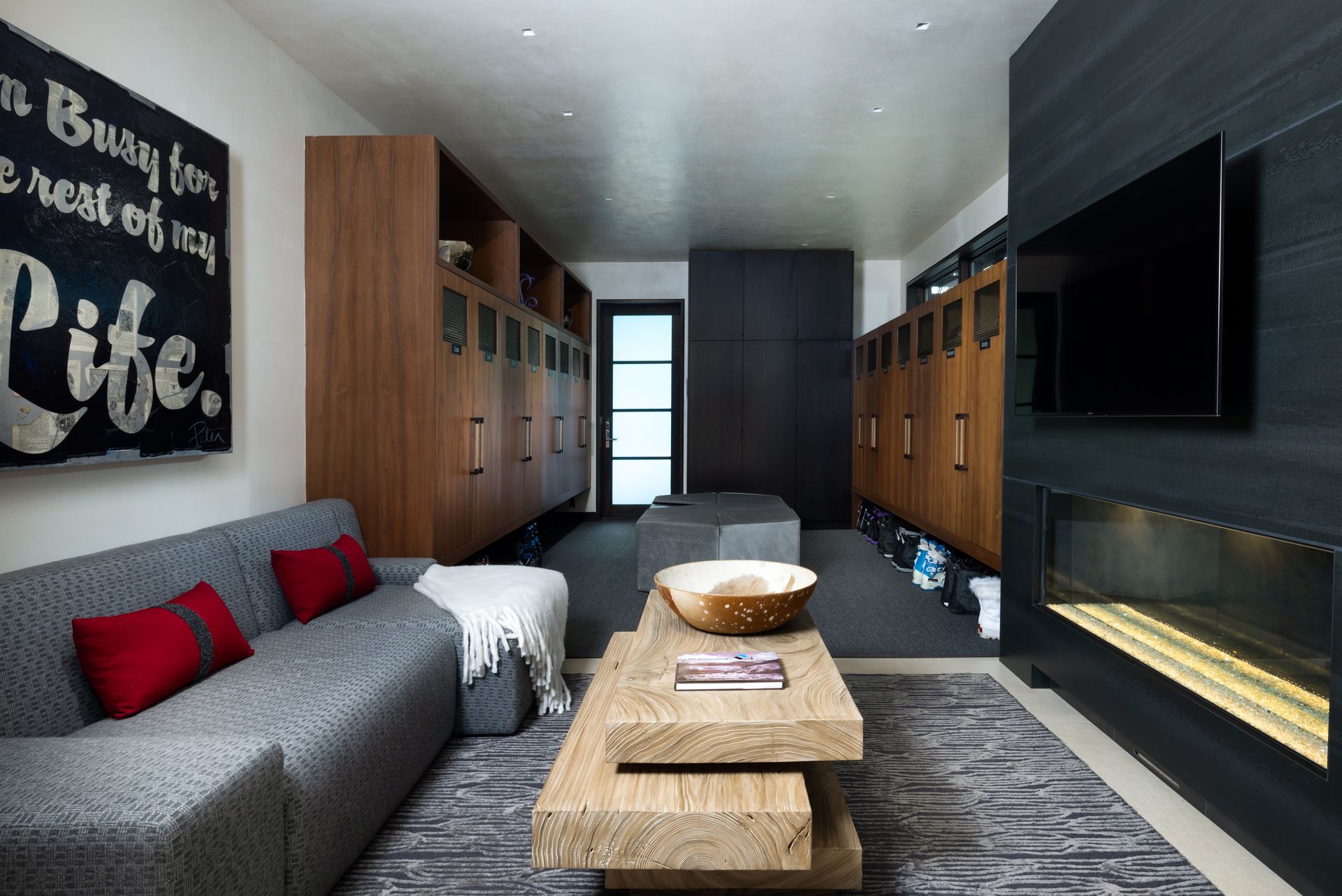 A living room with a couch and a fireplace and a sign that says life