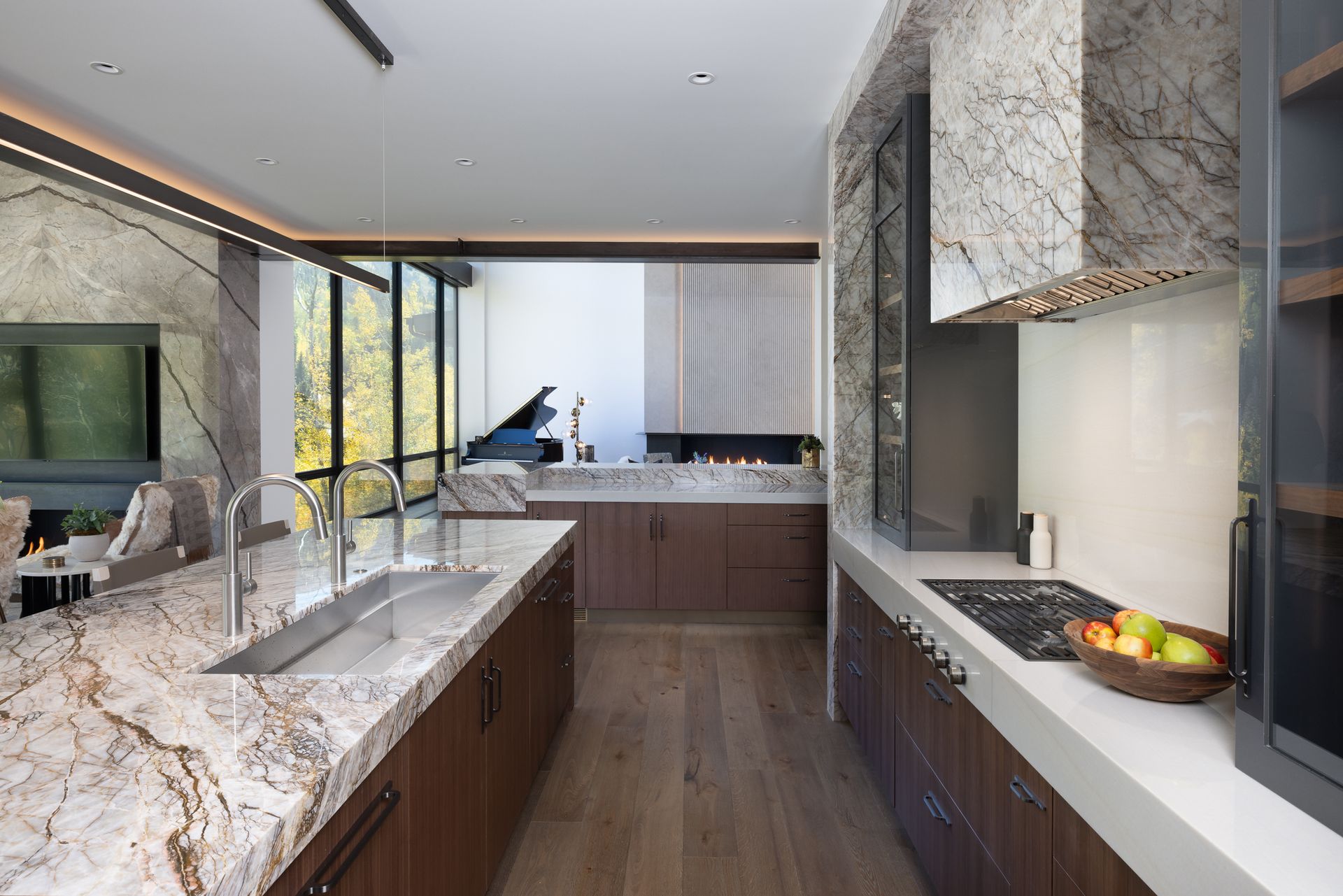 A kitchen with marble counter tops and wooden cabinets