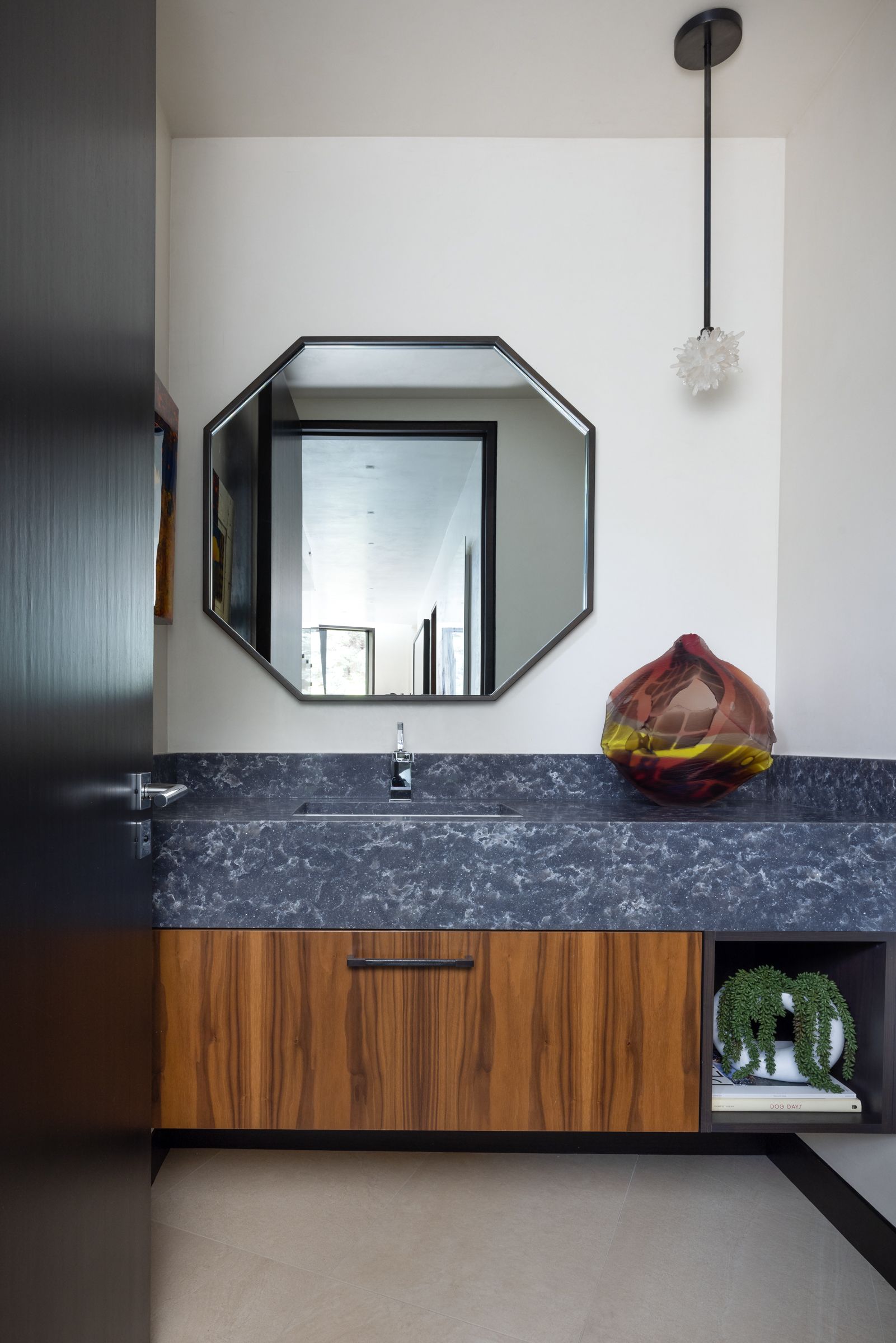 A bathroom with a large mirror and a sink