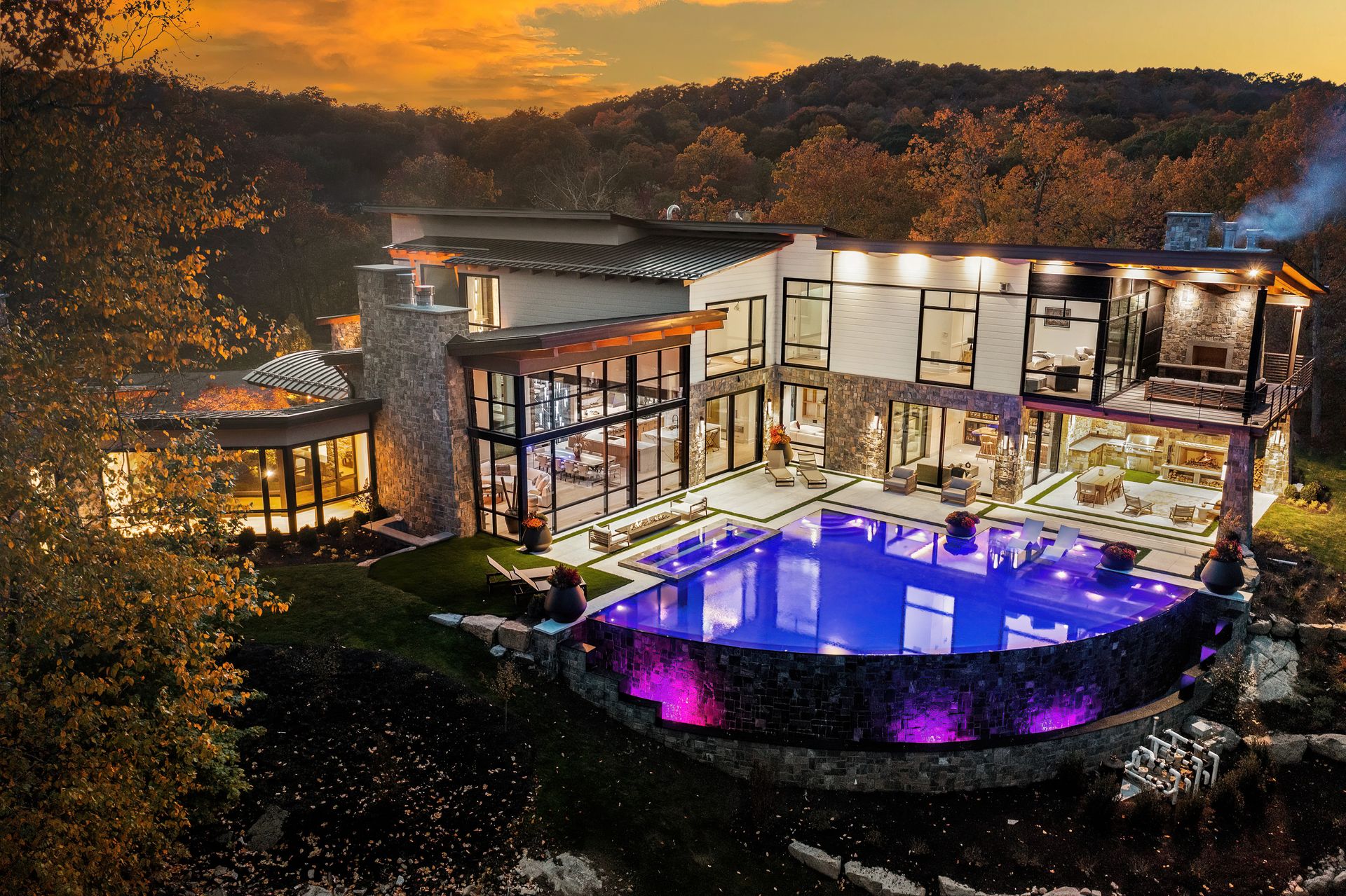 A large house with a swimming pool in front of it