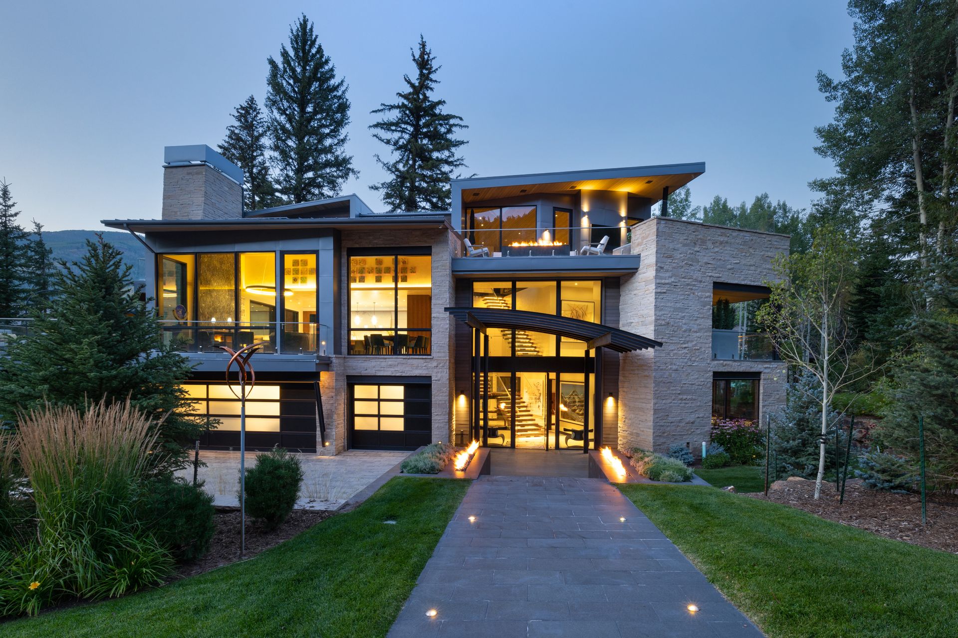 A large modern house with a driveway leading to it
