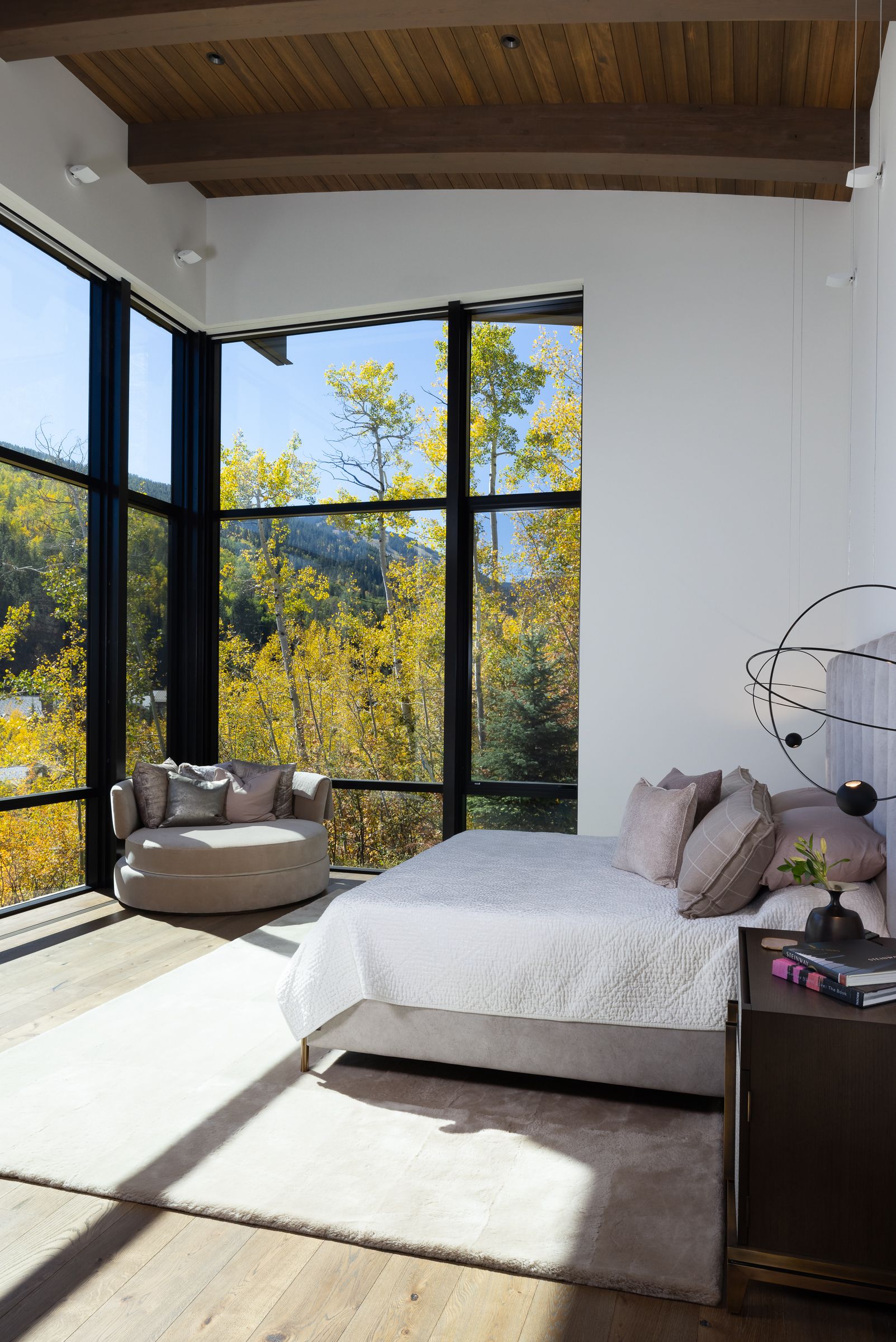 A bedroom with a large bed and lots of windows