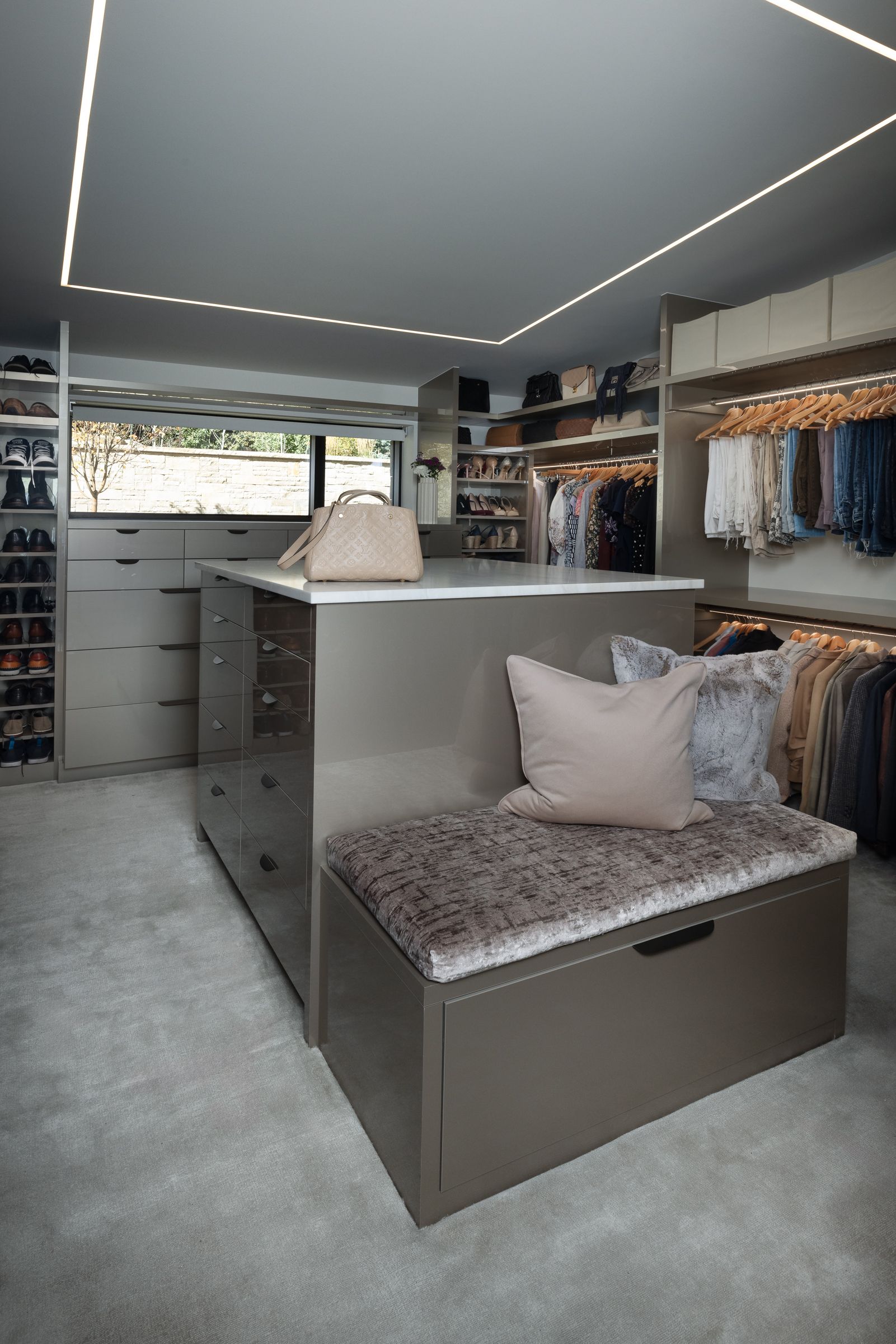 There is a bench in the middle of the closet.