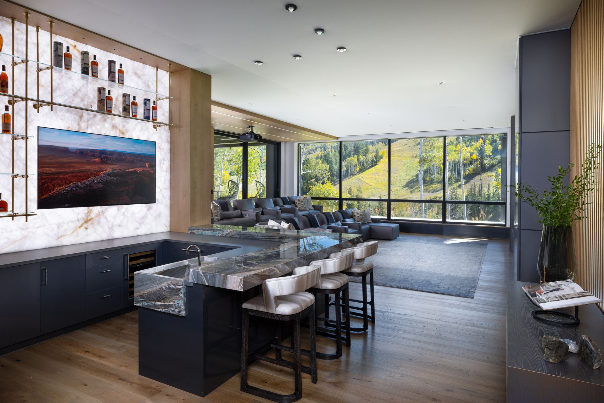 A large living room with a bar and a flat screen tv.