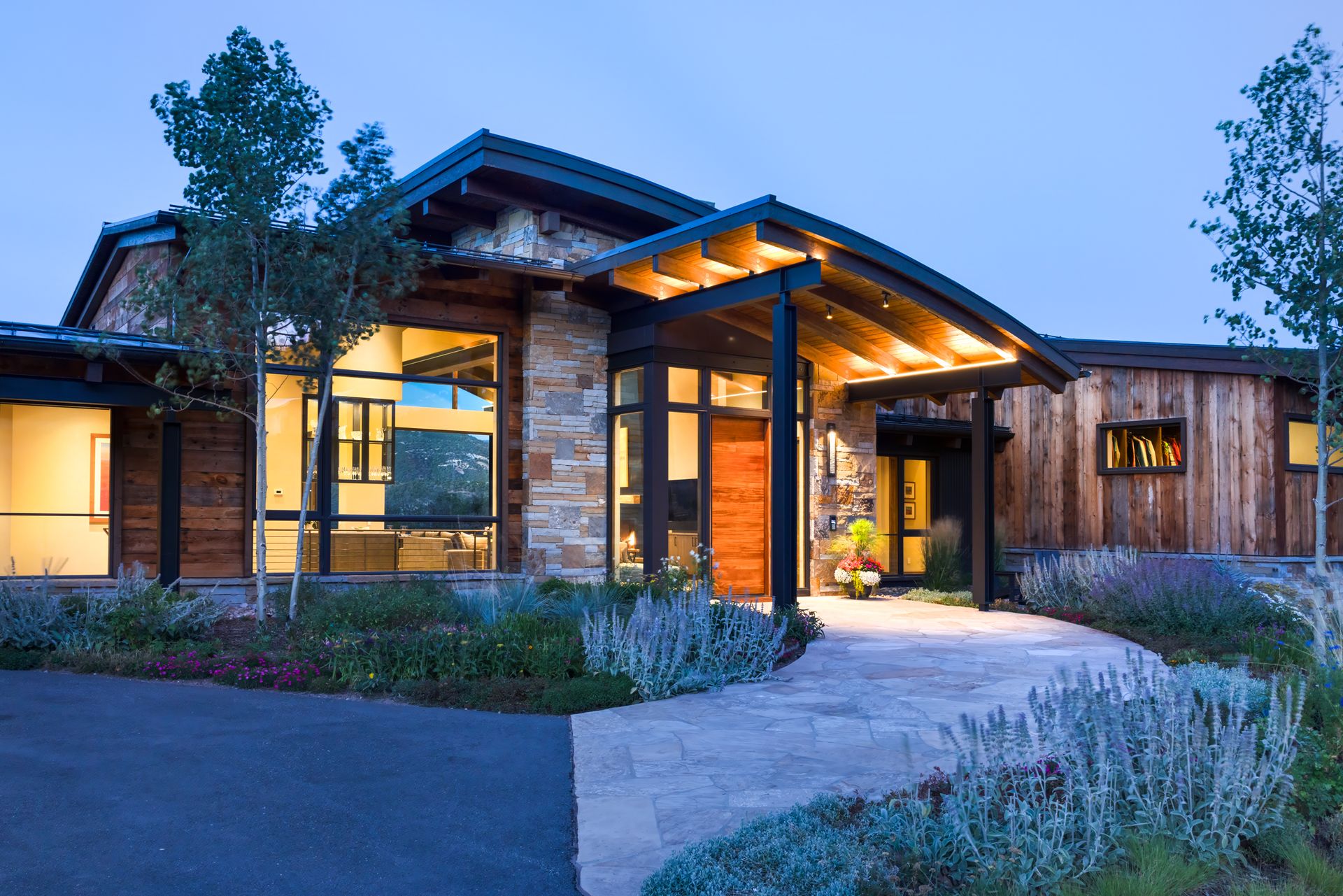 A large house with a lot of windows is lit up at night