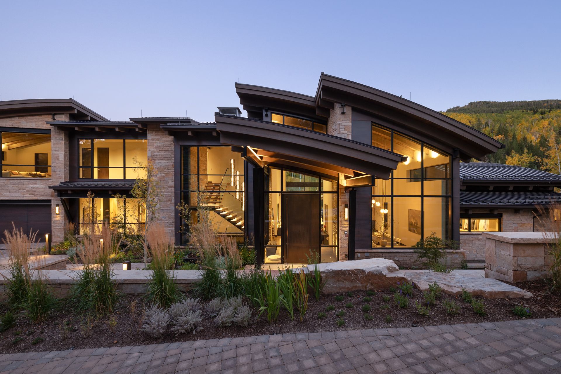 A large modern house with a curved roof and a lot of windows