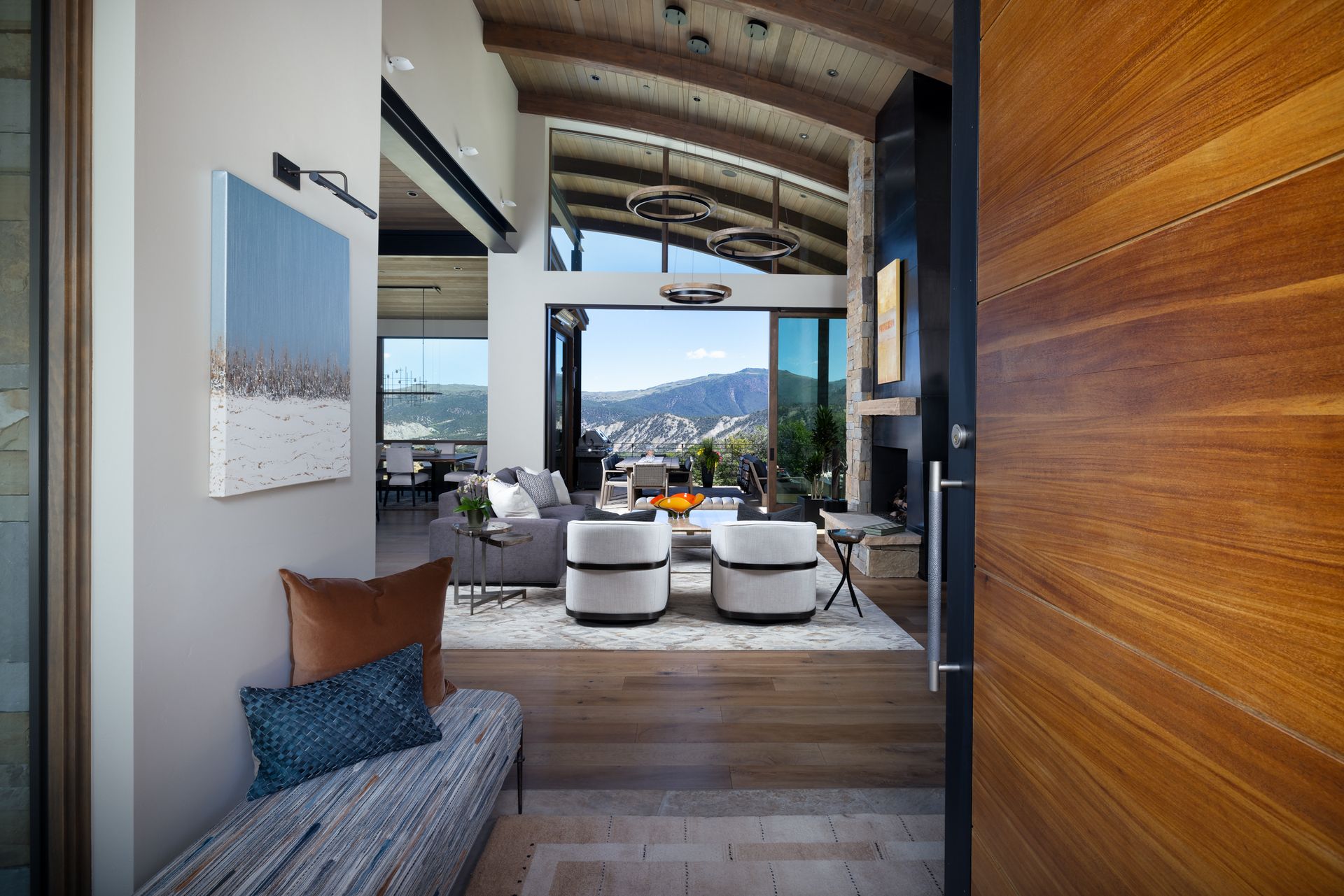 A living room with a large window and a wooden door.